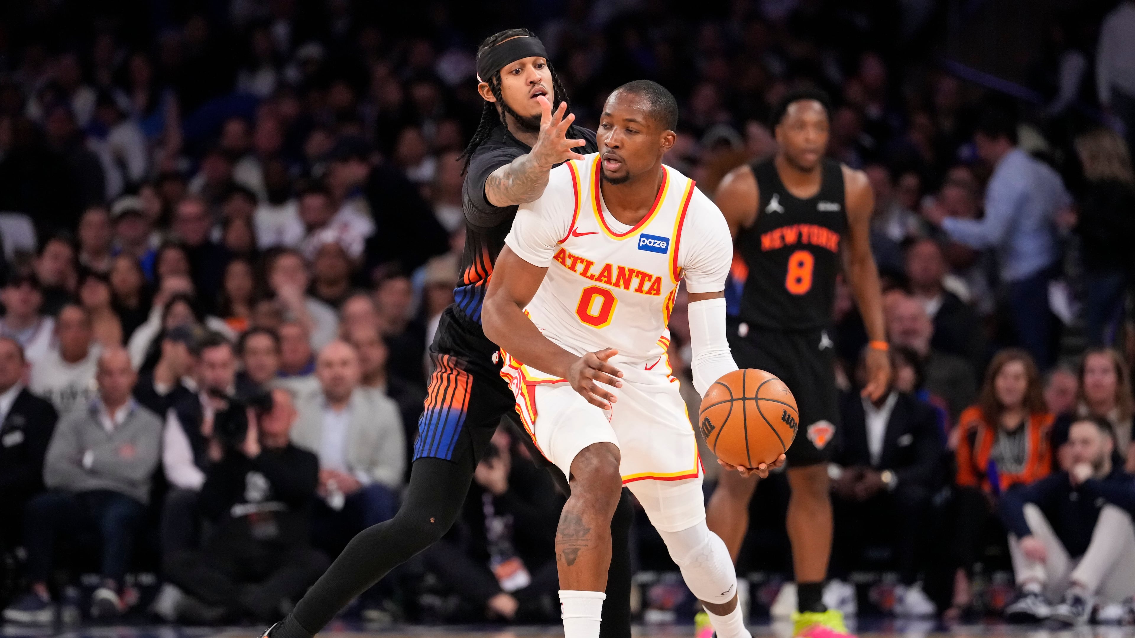 Atlanta Hawks forward Jonathan Kuminga (0) attempts to drive past New York Knicks guard Jordan Clarkson (00) during the first half in Game 2 of a first-round NBA playoffs basketball series, Monday, April 20, 2026, in New York. (AP Photo/Yuki Iwamura)