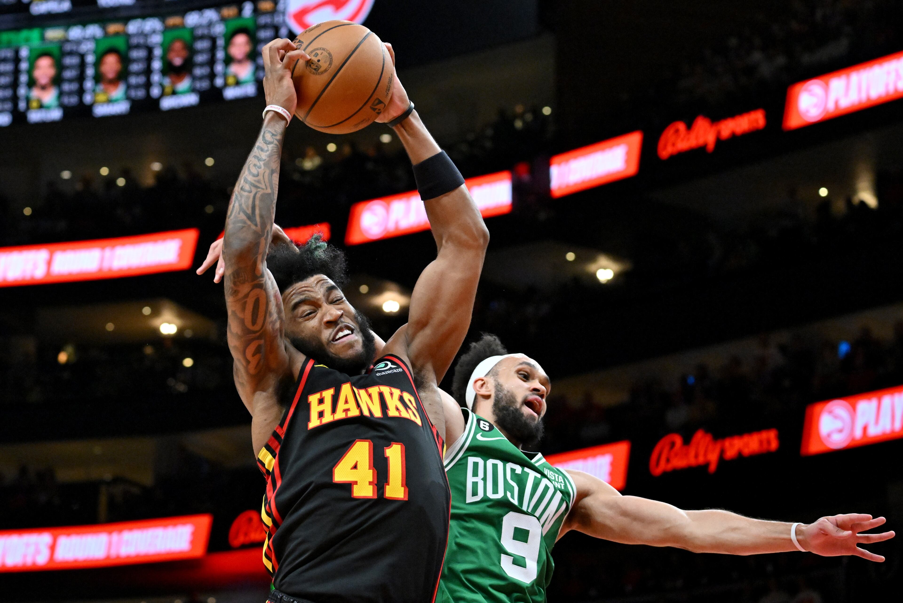 Atlanta Hawks' forward Saddiq Bey (41) grabs a rebound over Boston Celtics' guard Derrick White (9) during the second half. (Hyosub Shin / Hyosub.Shin@ajc.com)