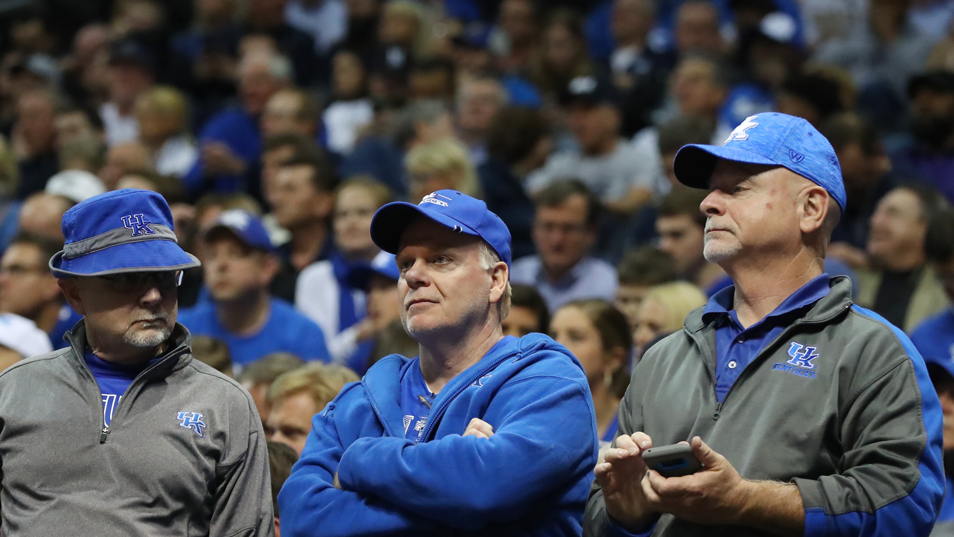 Unhappy Kentucky fans look on as Kansas State takes the lead in a regional semifinal NCAA Tournament game Thursday.