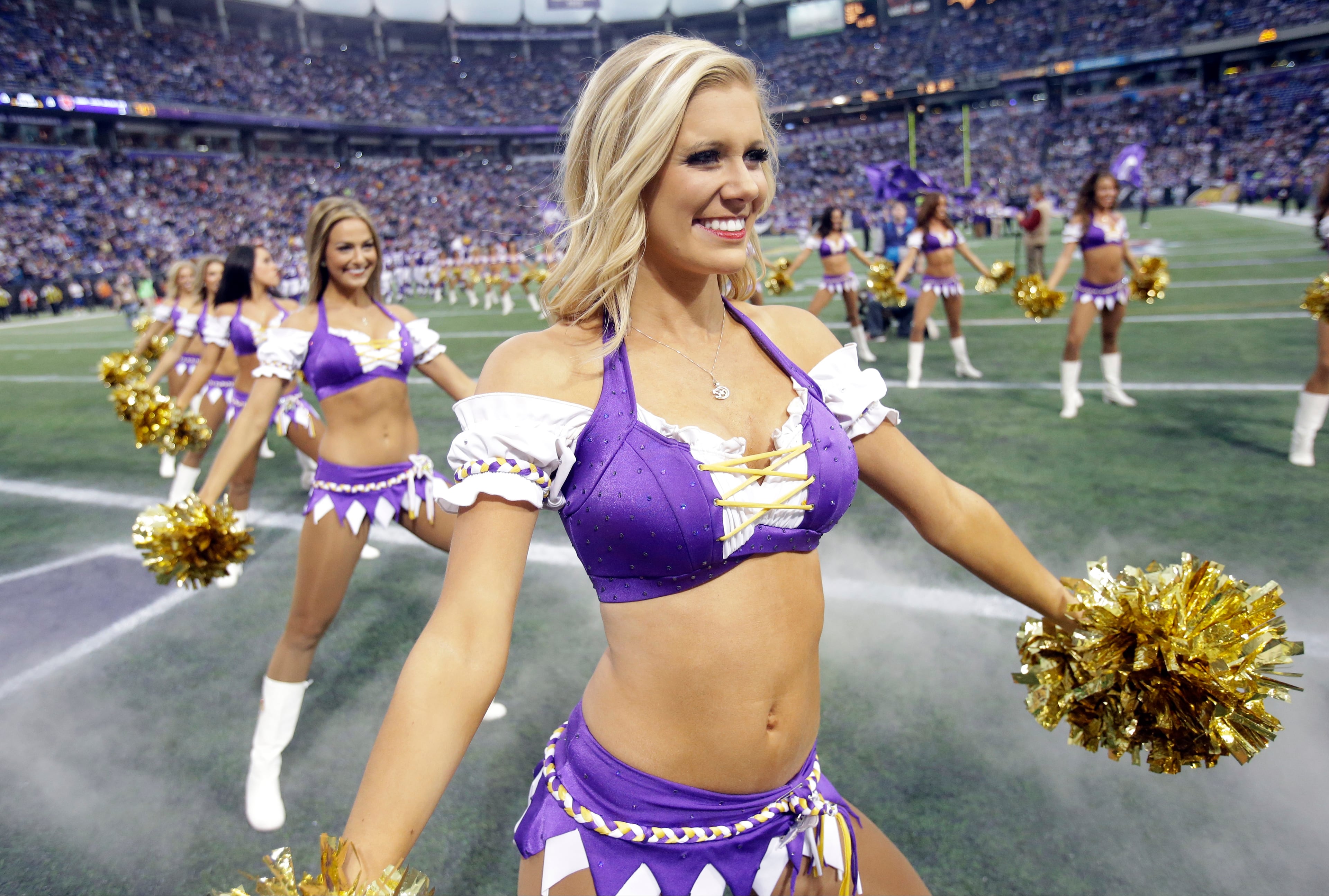 Cheerleaders stand ready for player introductions prior to an NFL football game between the Minnesota Vikings and the Chicago Bears on Dec. 1, 2013, in Minneapolis.