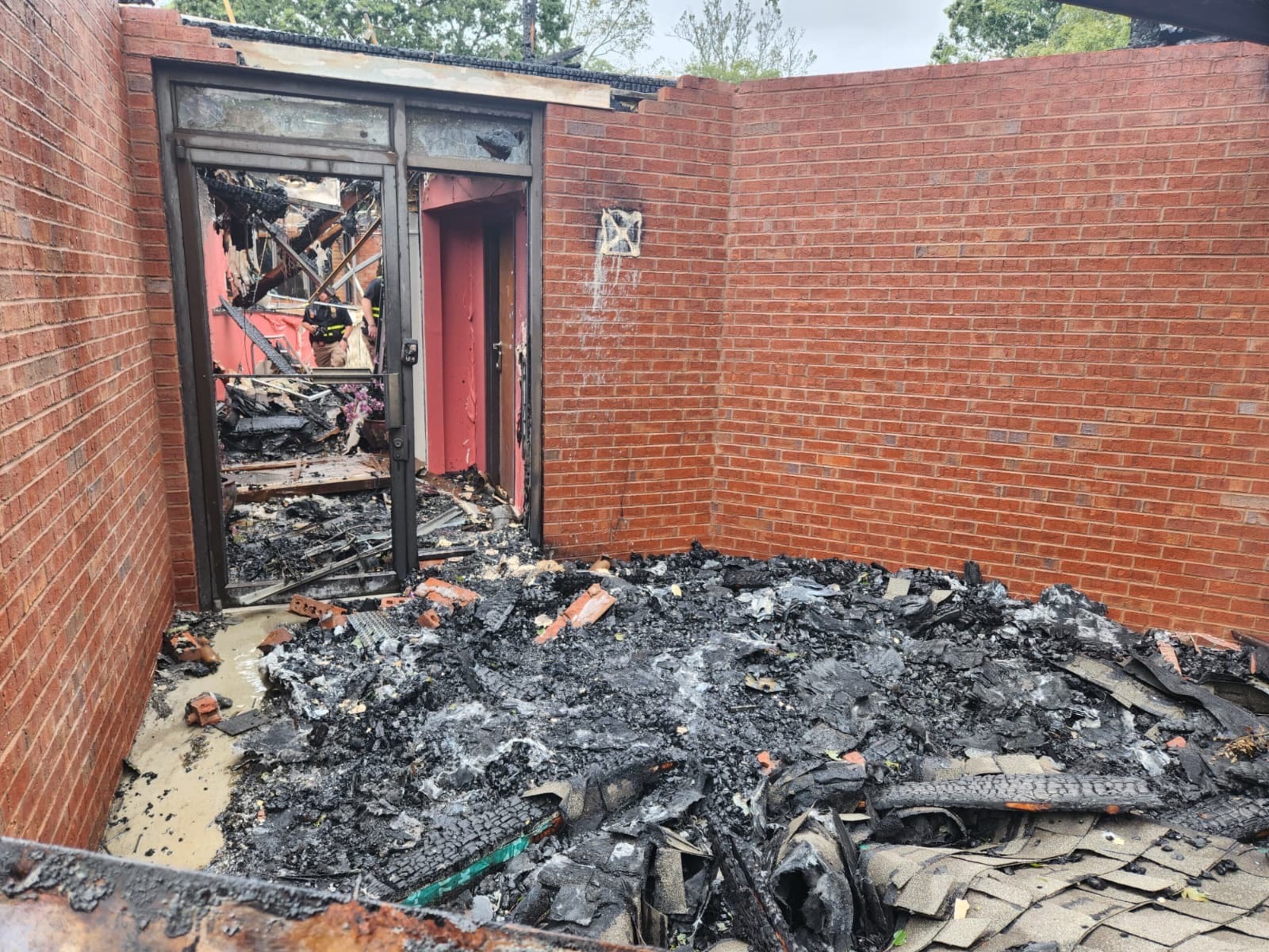 Ash covers the ground near an entrace to the Prayer City Eagles Chapel International Ministries in Austell after a fire on Monday, Sept. 29, 2025. (GoFundMe)
