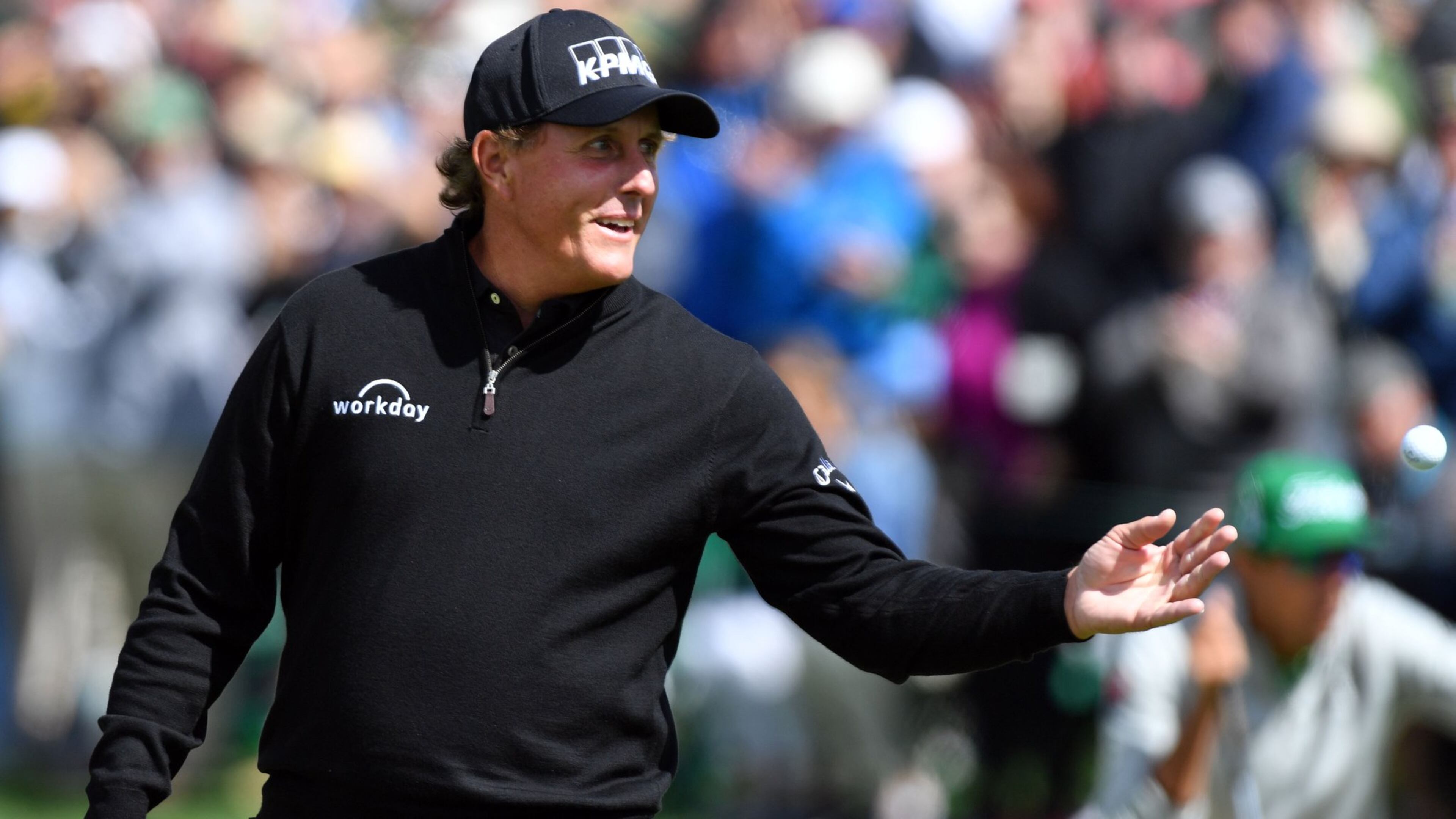 Phil Mickelson tosses his ball to caddie Jim Mackay following an eagle on the second green as he jump-started his round of 71 in the 81st Masters at the Augusta National Golf Club, Thursday April 6, 2017. BRANT SANDERLIN / SPECIAL