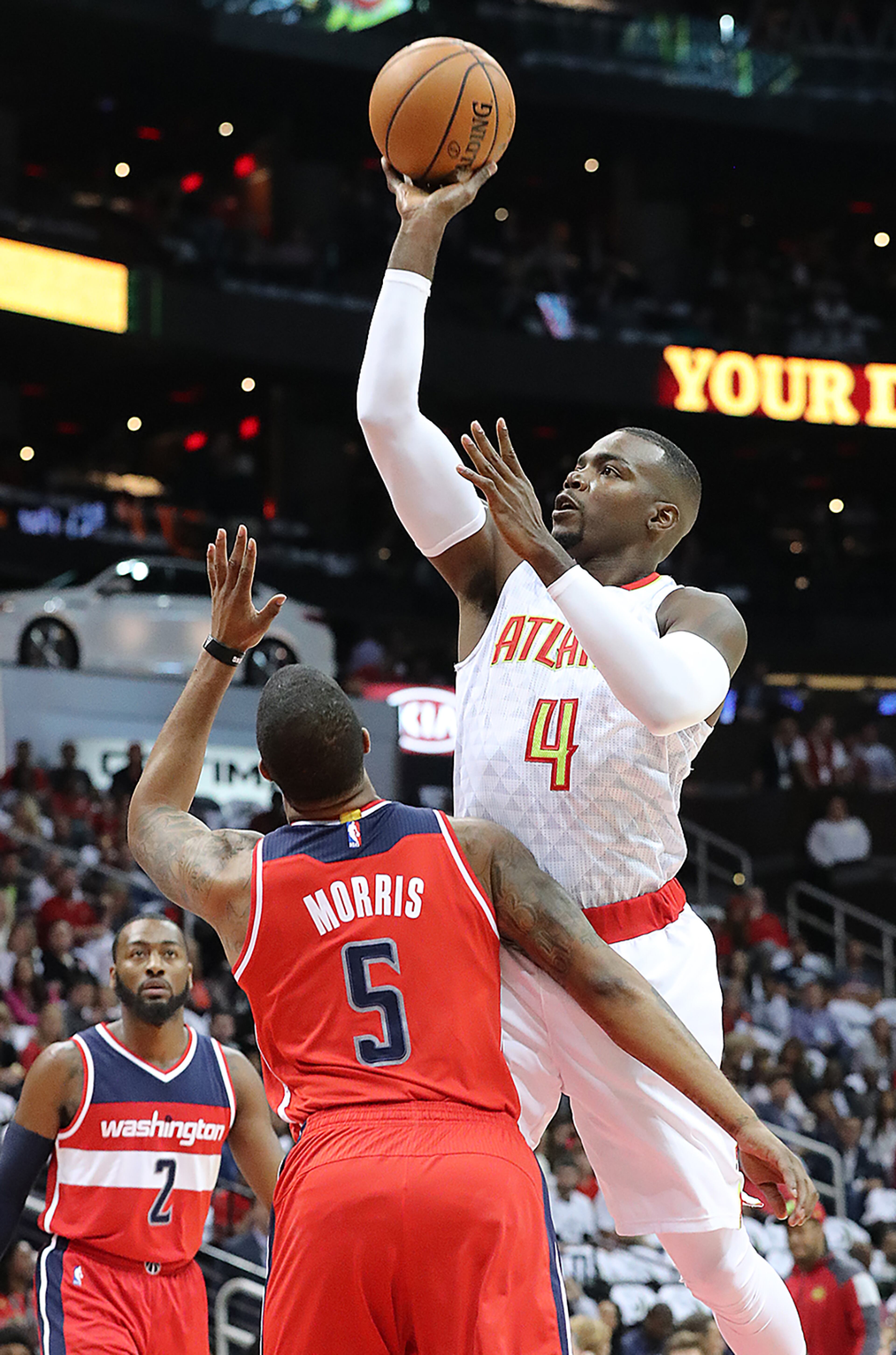 October 27, 2016 ATLANTA: Hawks Paul Millsap shoots for two over Wizards Markieff Morris during the first period in the home opener of their NBA basketball game at Philips Arena on Thursday, Oct. 27, 2016, in Atlanta. Curtis Compton /ccompton@ajc.com