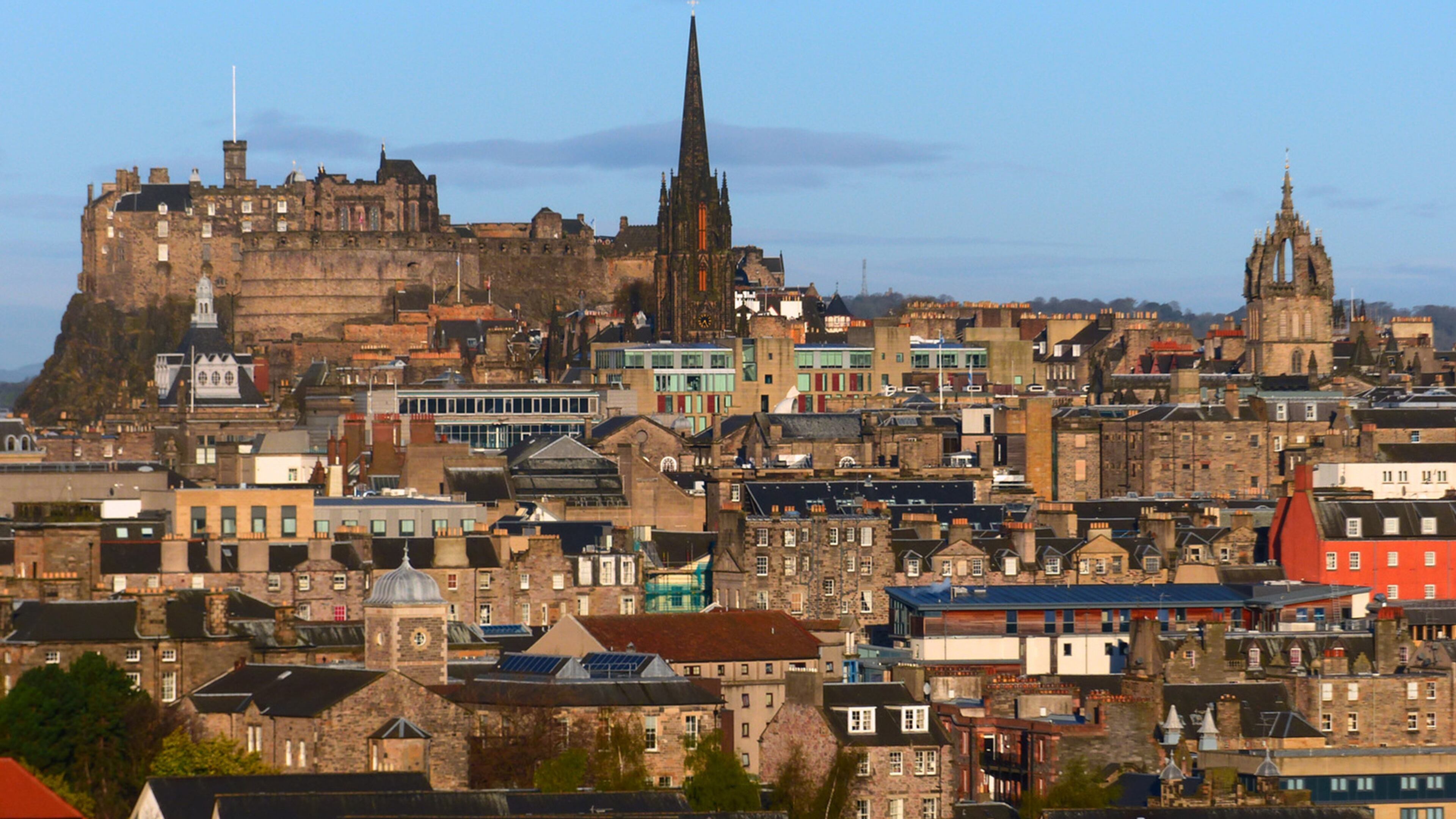 The higgledy-piggledy roofscape of Old Town Edinburgh is seen from the Radical Road trail at the foot of Salisbury Crags. Narrow, hidden "closes," or pedestrian alleyways, bisect many of the old buildings. (Brian J. Cantwell/The Seattle Times/TNS)