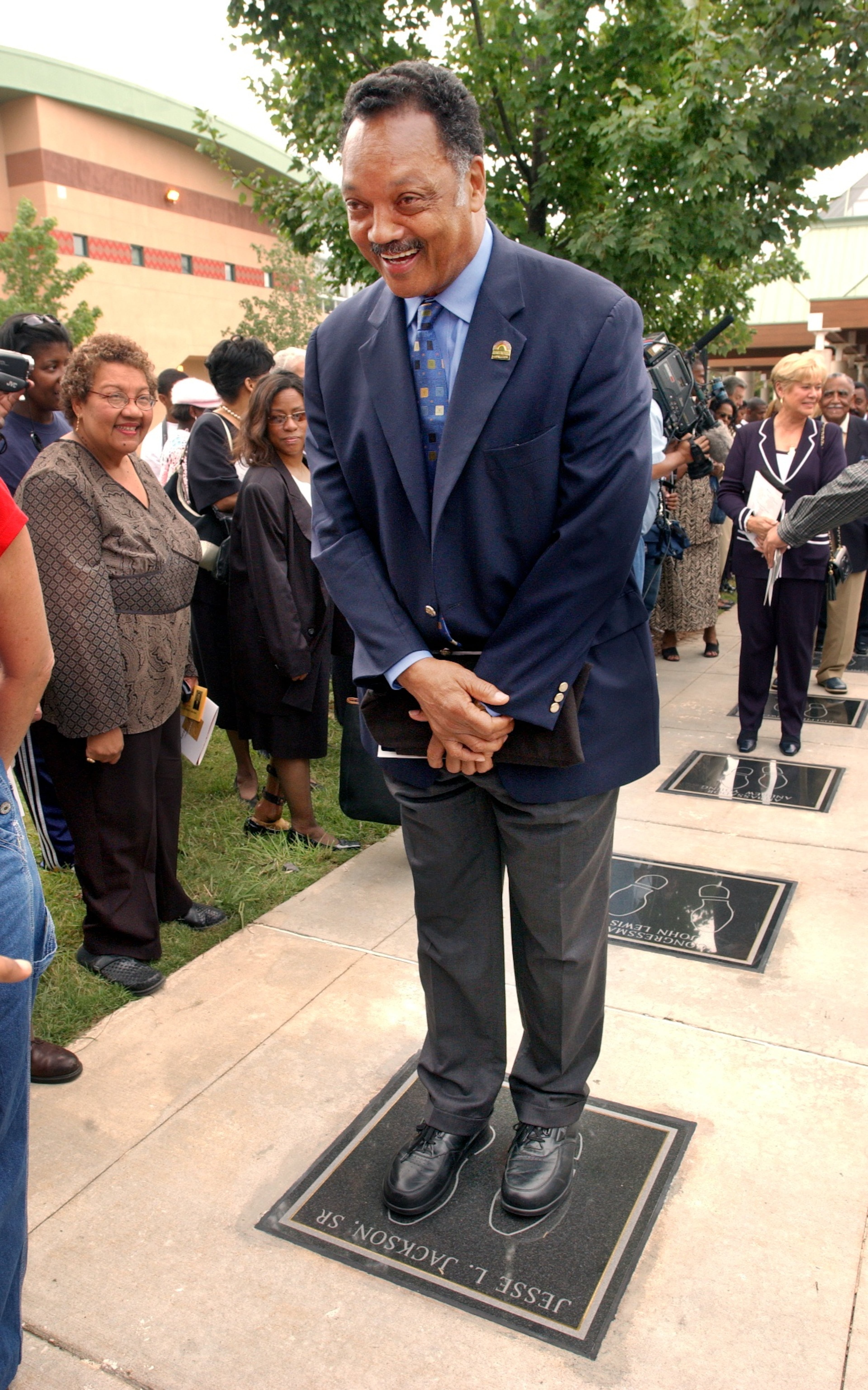Jackson stands in his footprint during the inaugural unveiling of the International Civil Rights Walk of Fame at the Martin Luther King Jr., National Historic site in Atlanta, April 14, 2004. (Joey Ivansco/AJC).