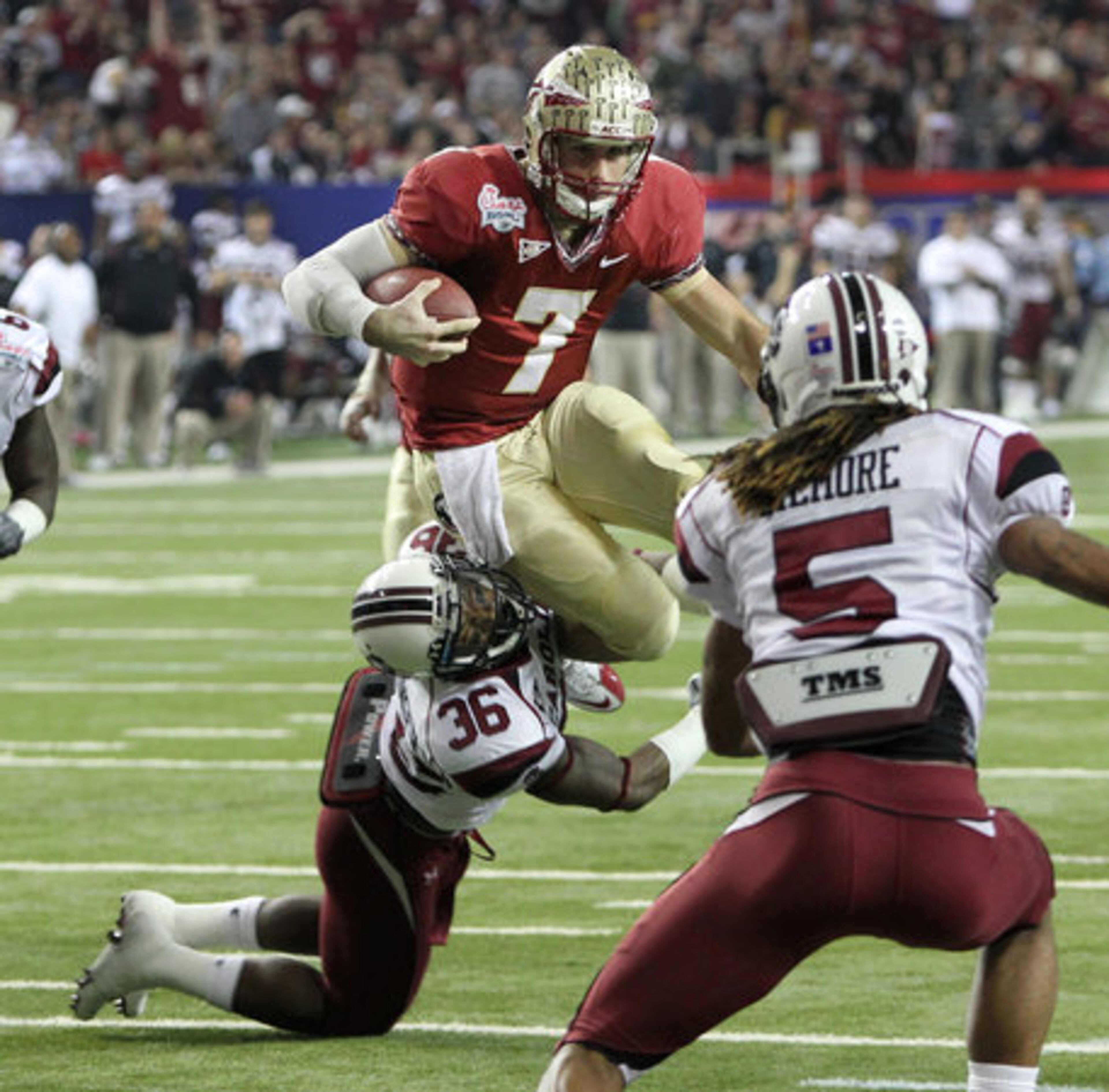 Florida State quarterback Christian Ponder trys to leap over South Carolina free safety D.J. Swearinger who makes the tackle on a quarterback keeper during 1st half action in the Chick-fil-A Bowl at the Georgia Dome in Atlanta on Friday, Dec. 31, 2010.
