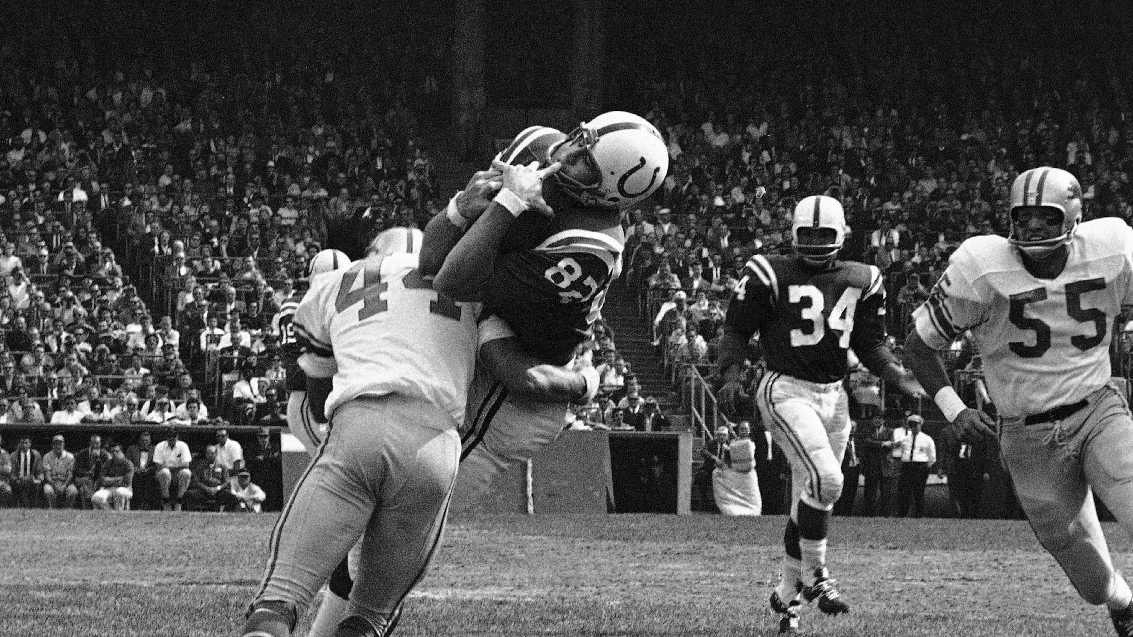 FILE - In this Sept. 30, 1962, file photo, Baltimore Colts end Raymond Berry snags a pass from quarterback John Unitas for 5-yard gain against the Detroit Lions in a football game in Baltimore. Lions' Dick LeBeau (44) makes the tackle. (AP Photo/File)