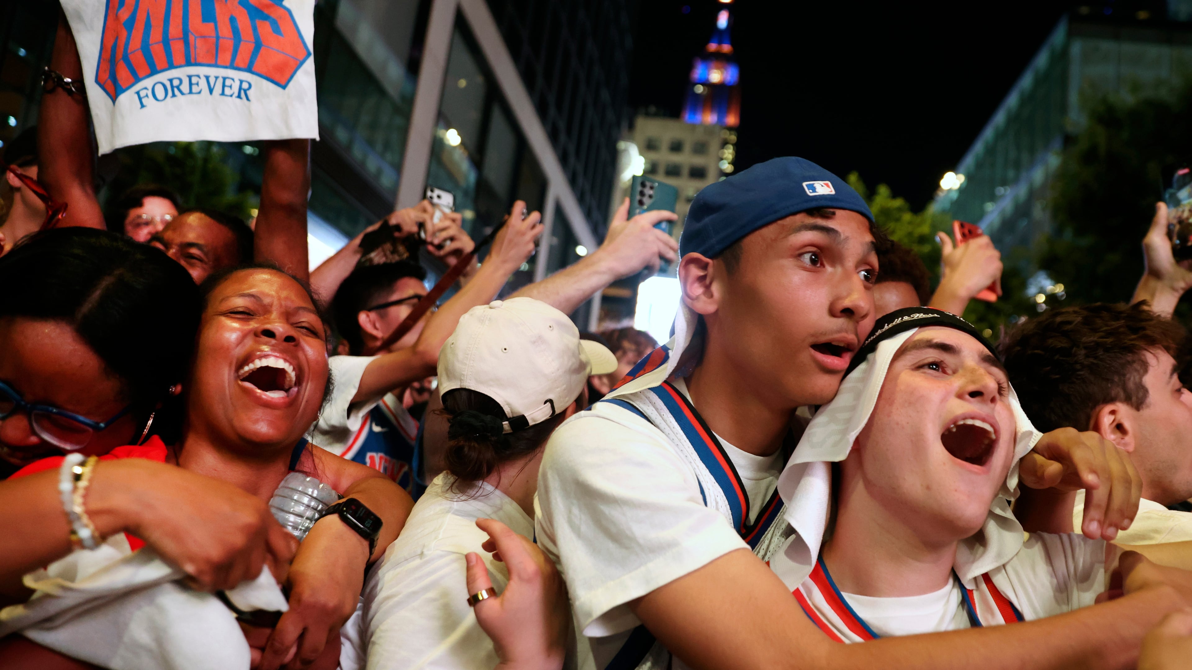 New York Knicks fans celebrate after winning Game 5 of the NBA Finals basketball series against the San Antonio Spurs, Saturday, June 13, 2026, in New York. (AP Photo/Heather Khalifa)