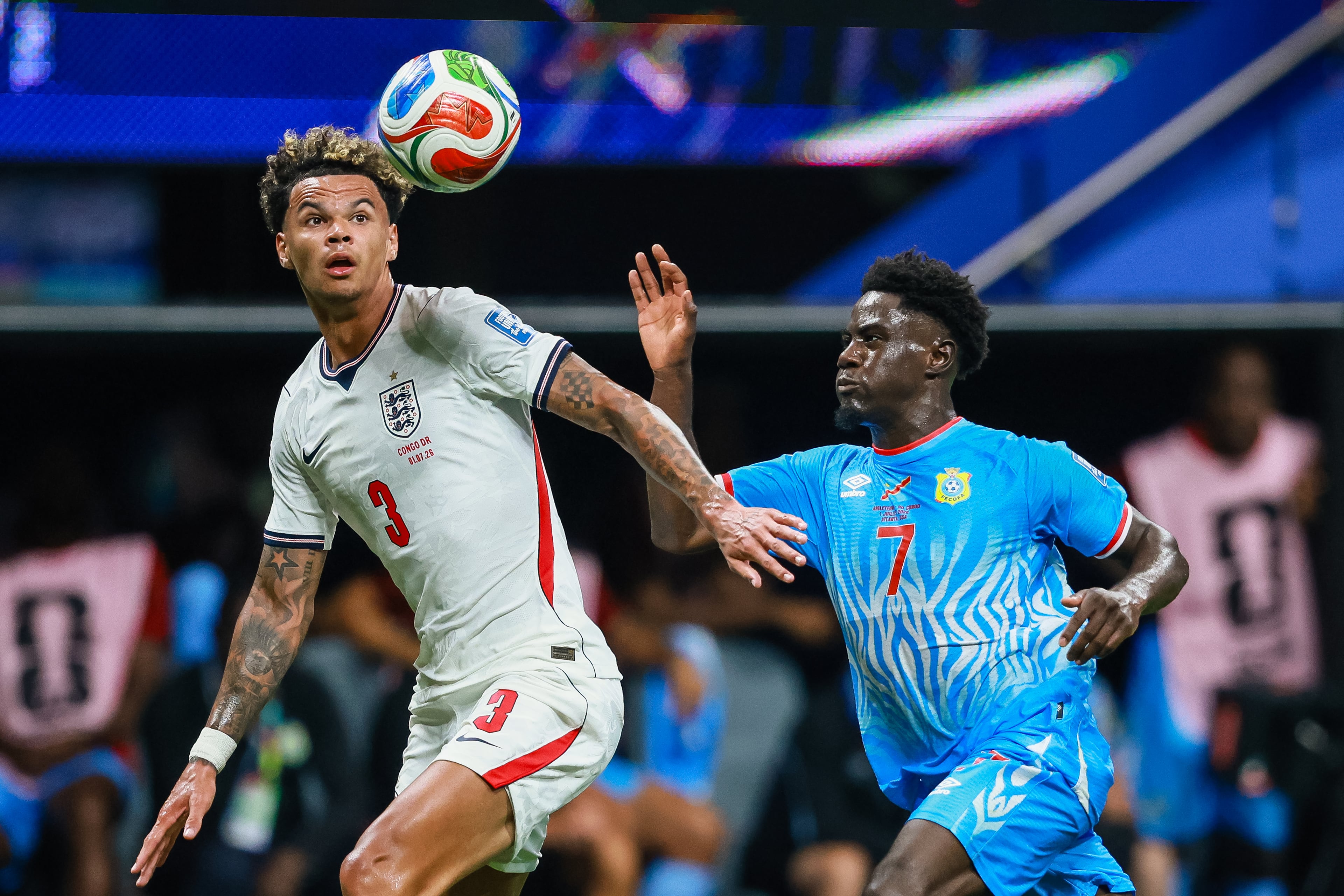 England defender Nico O'Reilly (left) keeps his eyes on the ball under pressure from Congo forward Nathanaël Mbuku (right) during the first half of a FIFA World Cup round of 32 match at Atlanta Stadium (Mercedes-Benz Stadium) on Wednesday, July 1, 2026, in Atlanta. (Jason Getz/AJC)