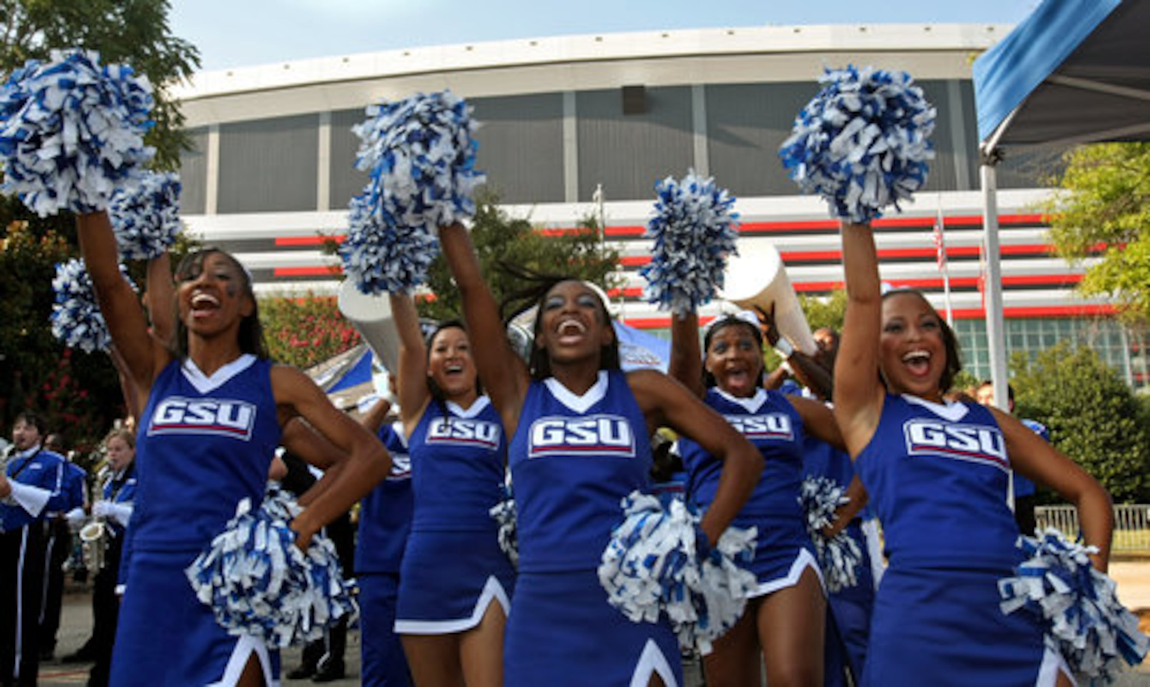 Georgia State University cheerleaders get the GSU alumni fired up in the GSU alumni section of the orange lot in front of the Georgia Dome in preparation for GSU's inaugural game against Shorter College in the Georgia Dome Thursday night in Atlanta, Ga., Sept. 2, 2010.