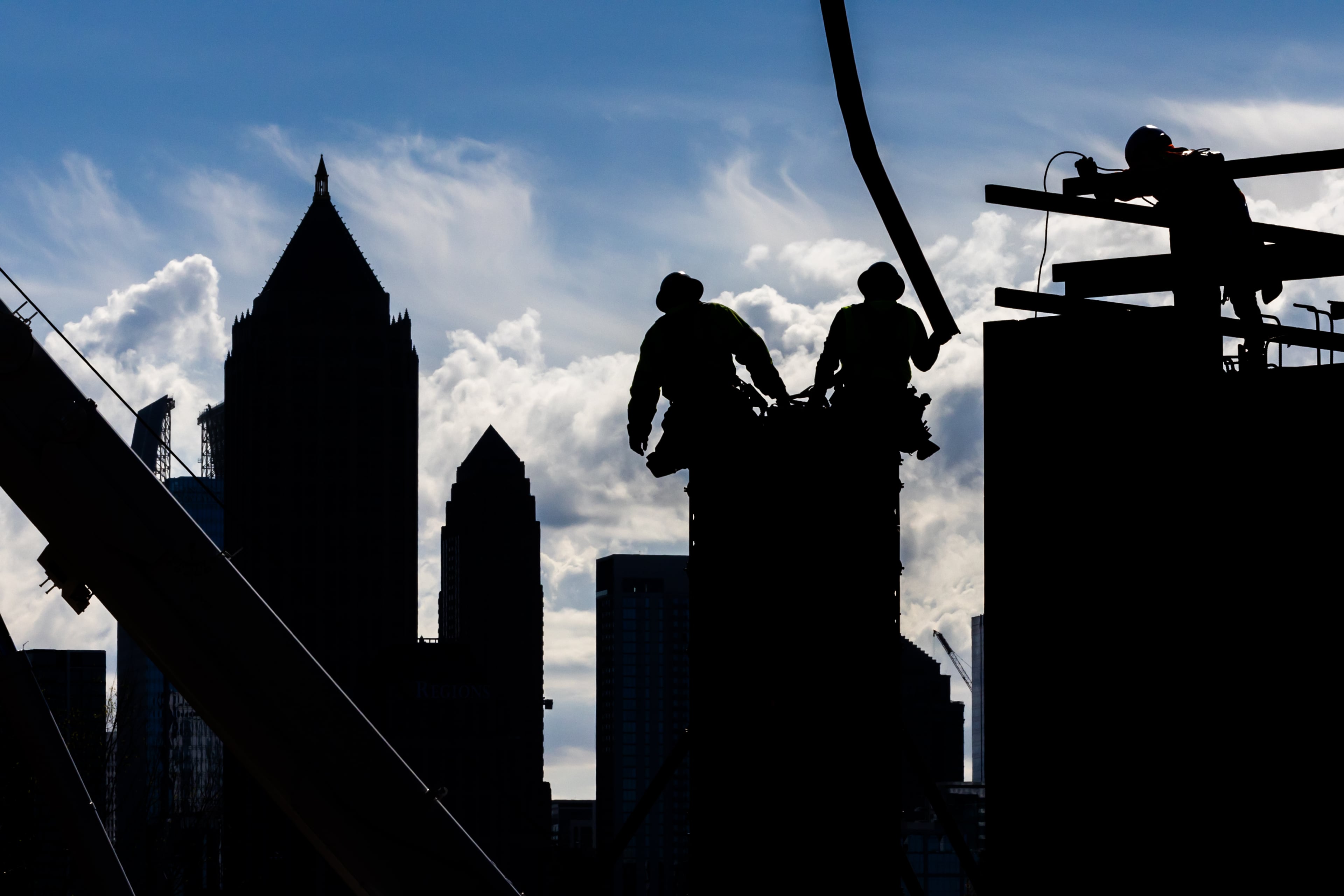 Construction workers pour concrete into forms along Bishop Street near 17th Street in West Midtown Atlanta in 2024 as they work on a mixed-use project called UrbA ATL. Much has changed over the past 30 years in Atlanta, both the city and the region, in terms of size, diversity, and population. (John Spink/AJC 2024)