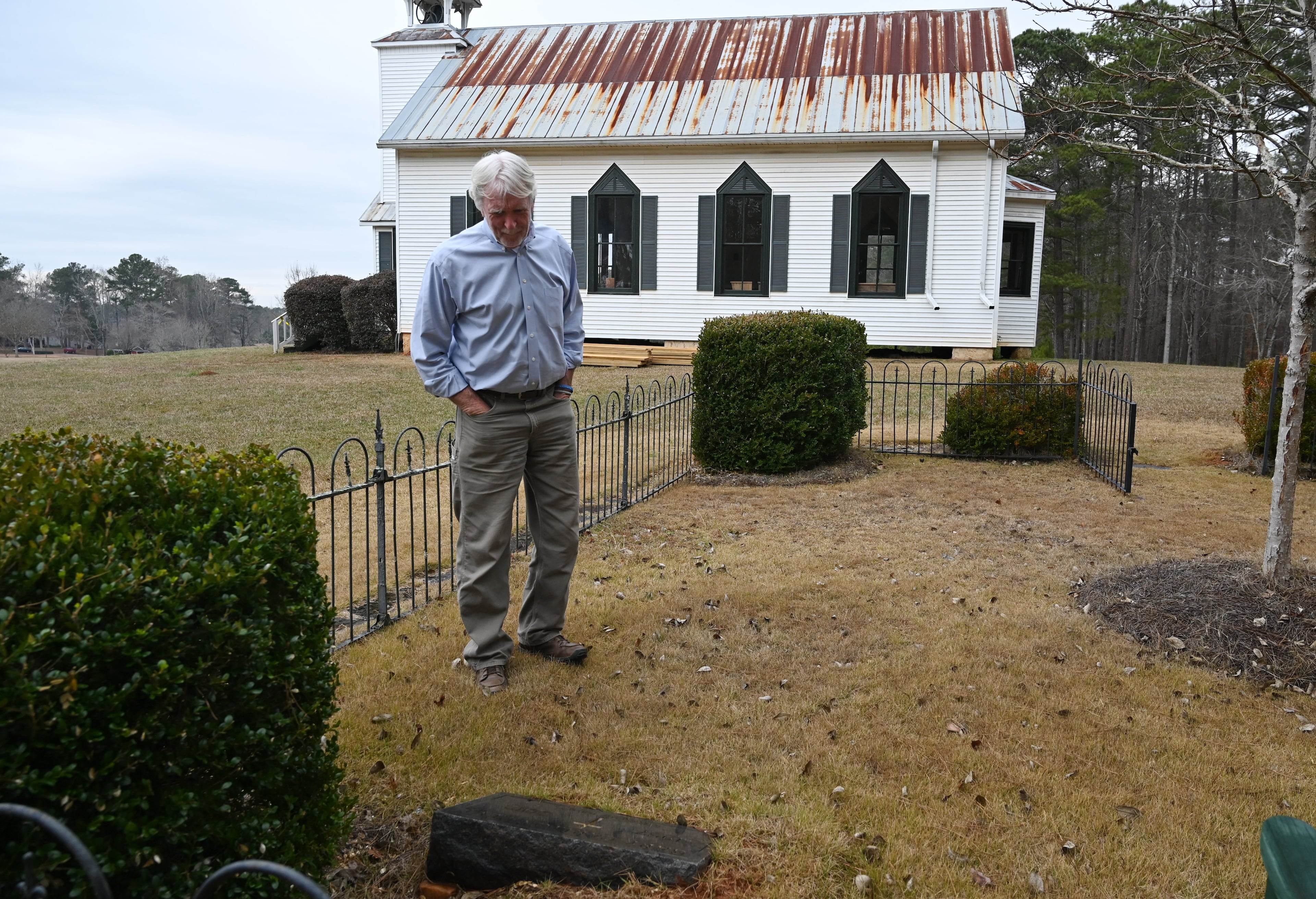 Allen Levi stands near his brother’s grave. Gary Levi died in 2012. (Hyosub Shin/AJC)