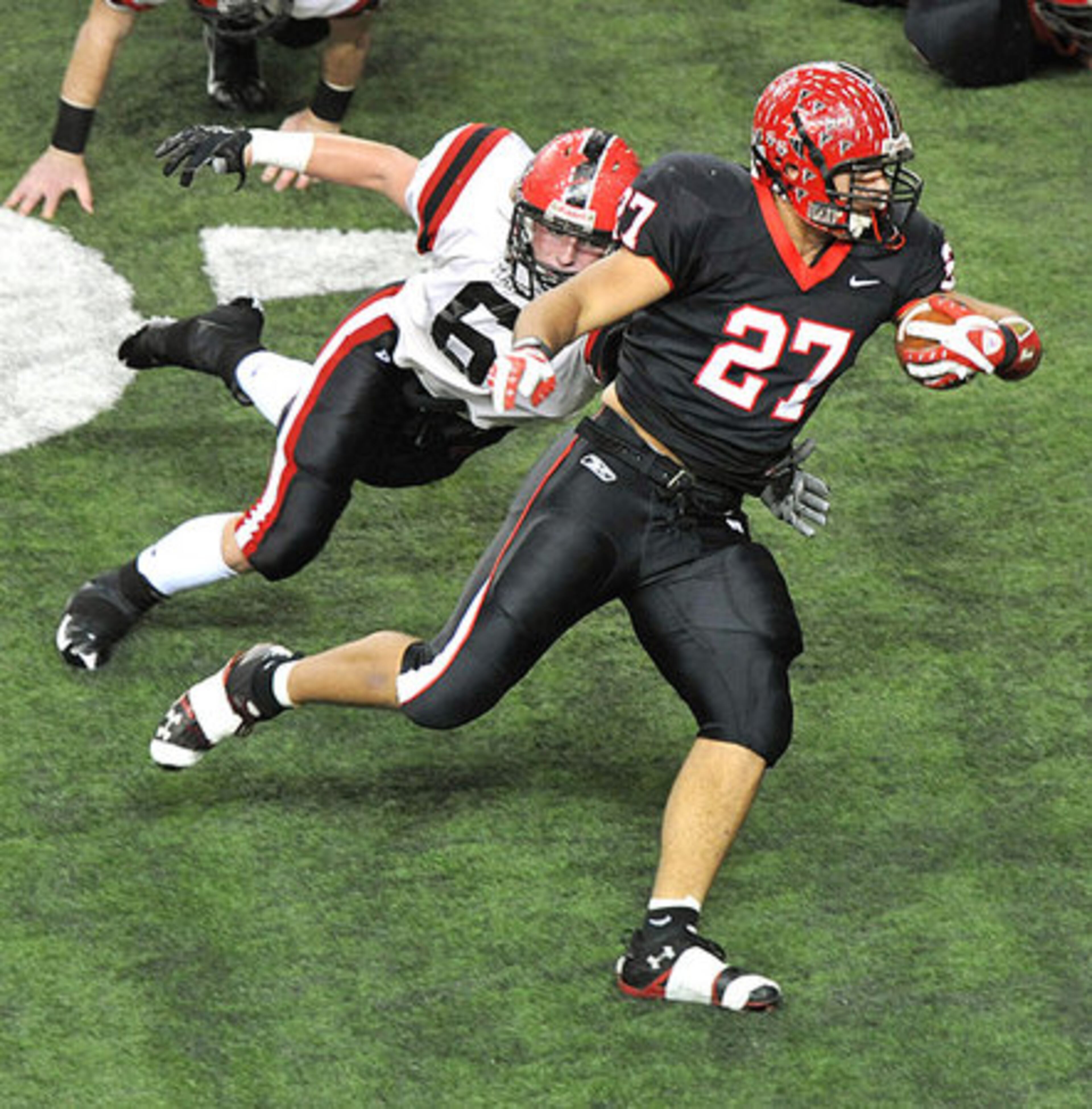 Flowery Branch's Daniel Drummond (27) escapes the grasp of Cairo's Jake Elkins (6).