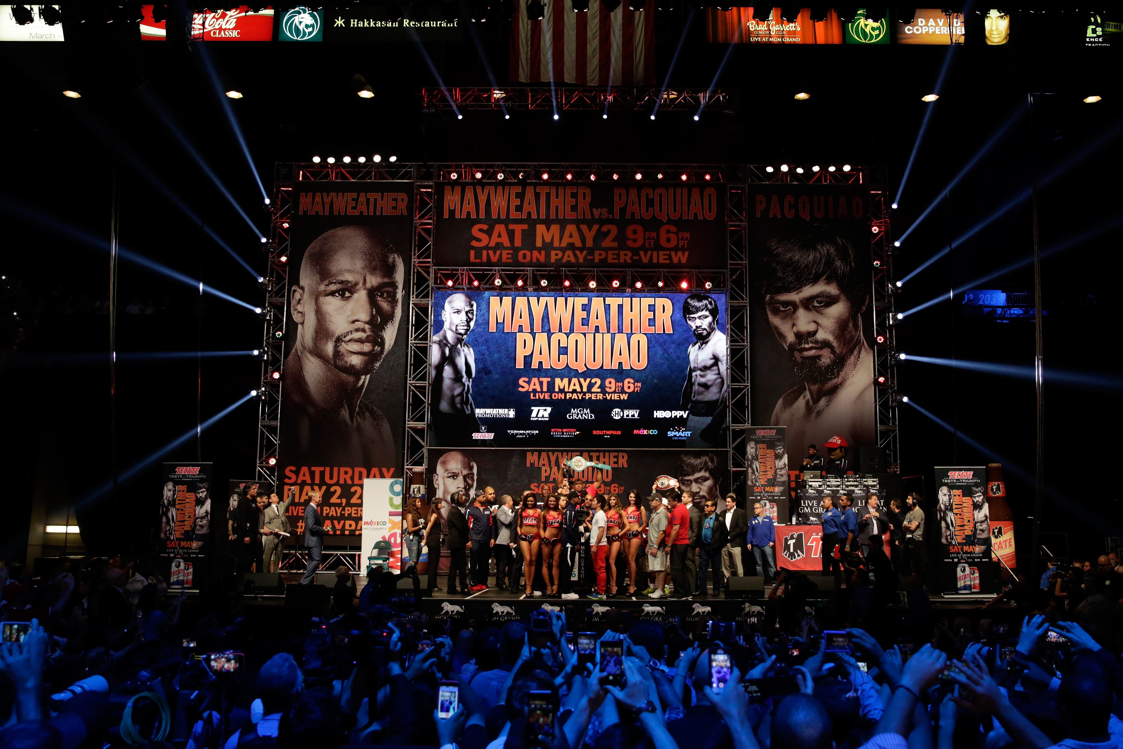 LAS VEGAS, NV - MAY 01: Floyd Mayweather Jr. (L) and Manny Pacquiao face-off during their official weigh-in on May 1, 2015 at MGM Grand Garden Arena in Las Vegas, Nevada. The two will face each other in a welterweight unification bout on May 2, 2015 in Las Vegas. (Photo by Jamie Squire/Getty Images)