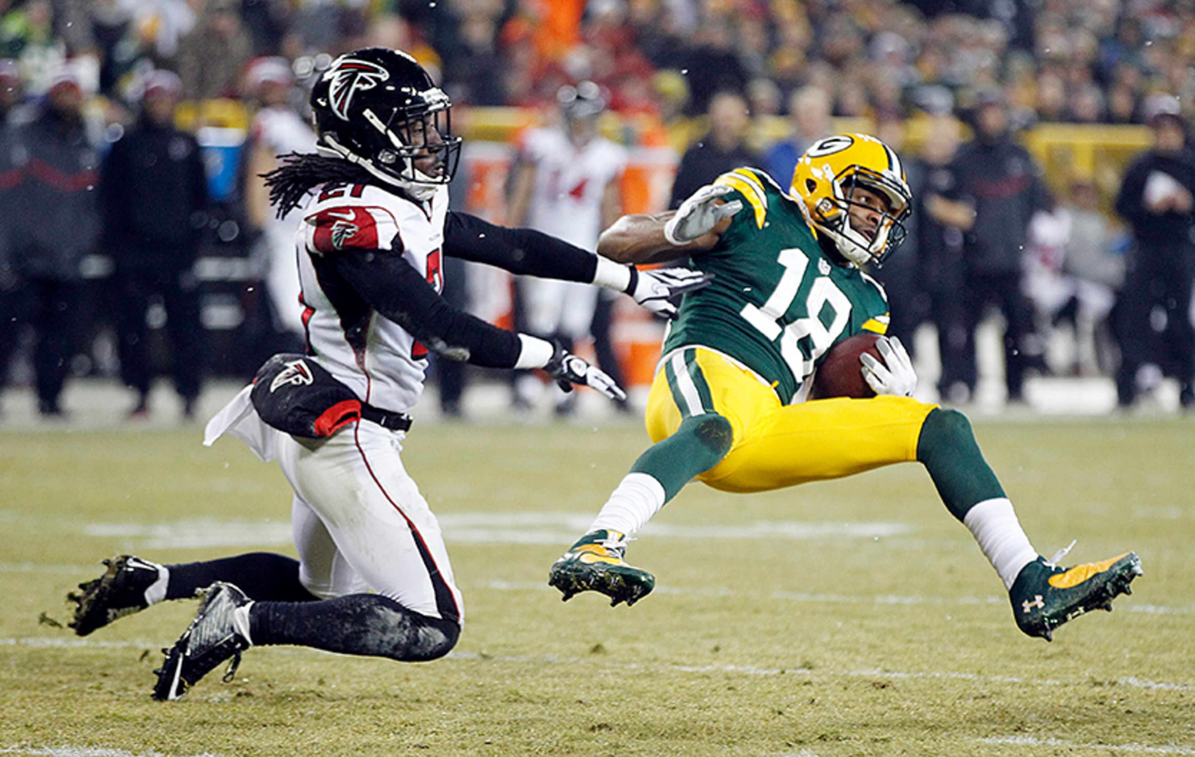 Atlanta Falcons cornerback Desmond Trufant tackles Green Bay Packers' Randall Cobb (18) after a catch during the first half Monday, Dec. 8, 2014, in Green Bay, Wis.