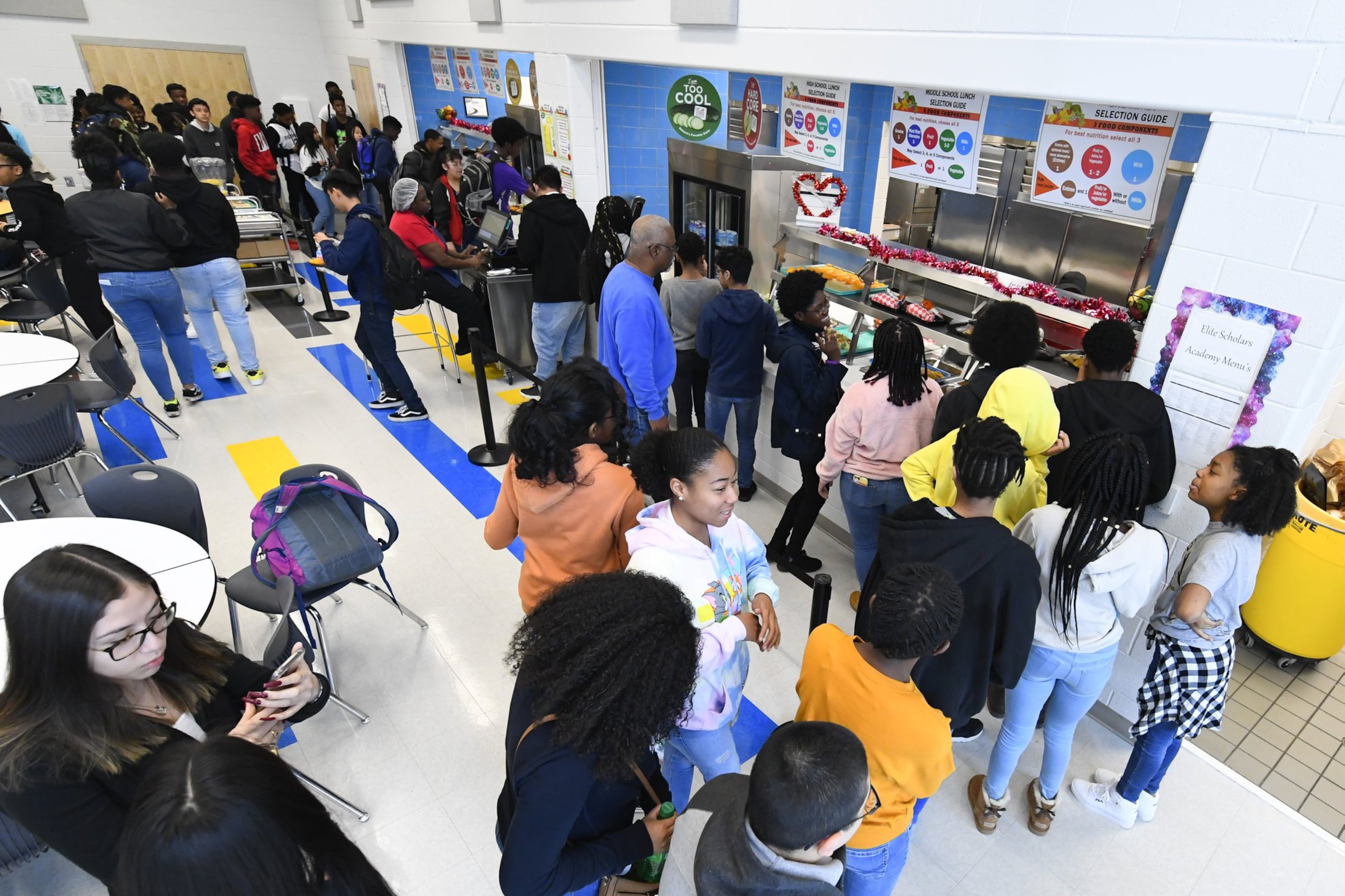 Students line up for lunch in the cafeteria at Elite Scholars Academy in Jonesboro on Jan. 17, 2020. Meals are free for all students in the Clayton County schools.