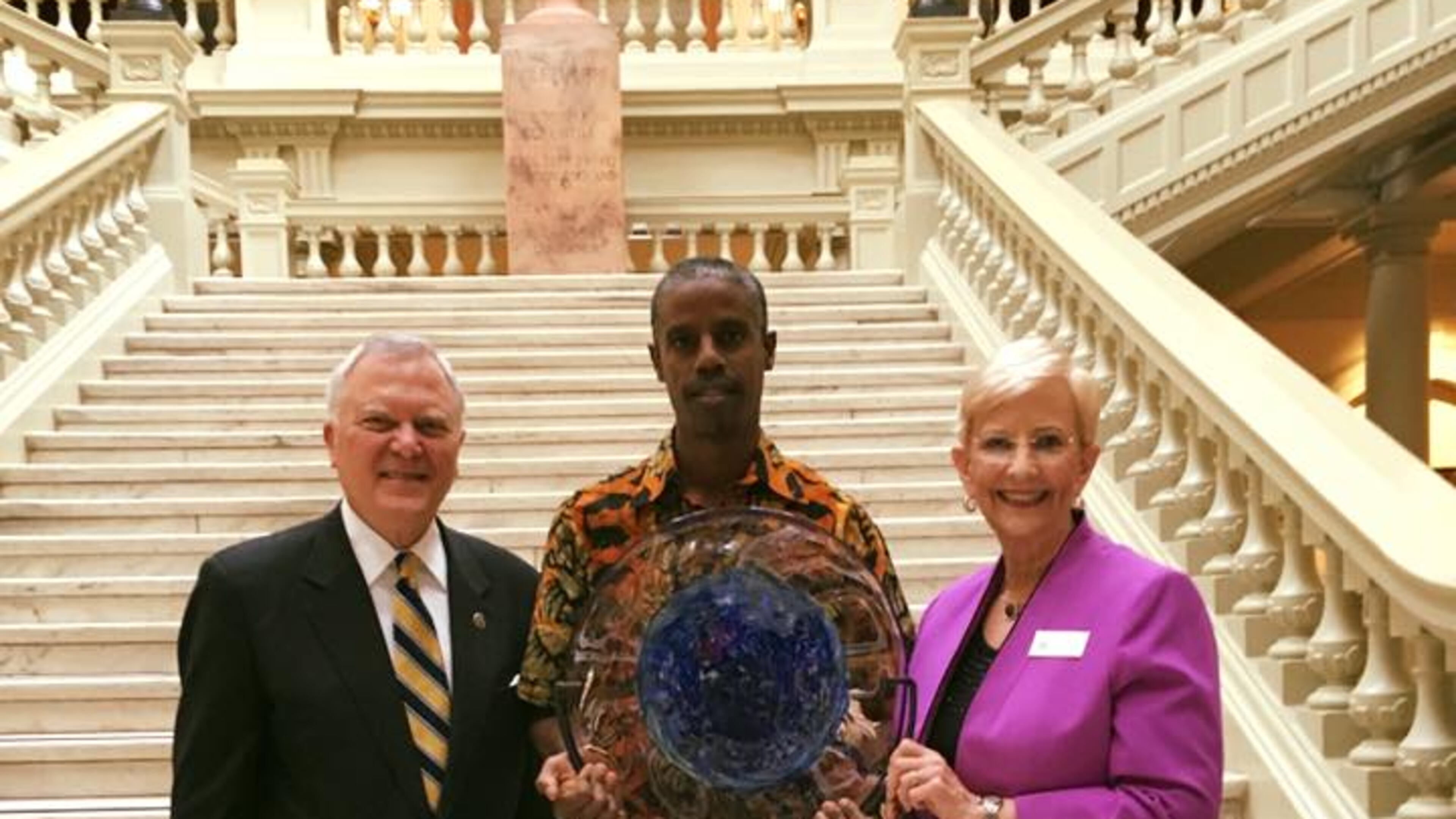 Mausiki Scales receives his award from Gov. Nathan Deal and First Lady Sandra Deal.