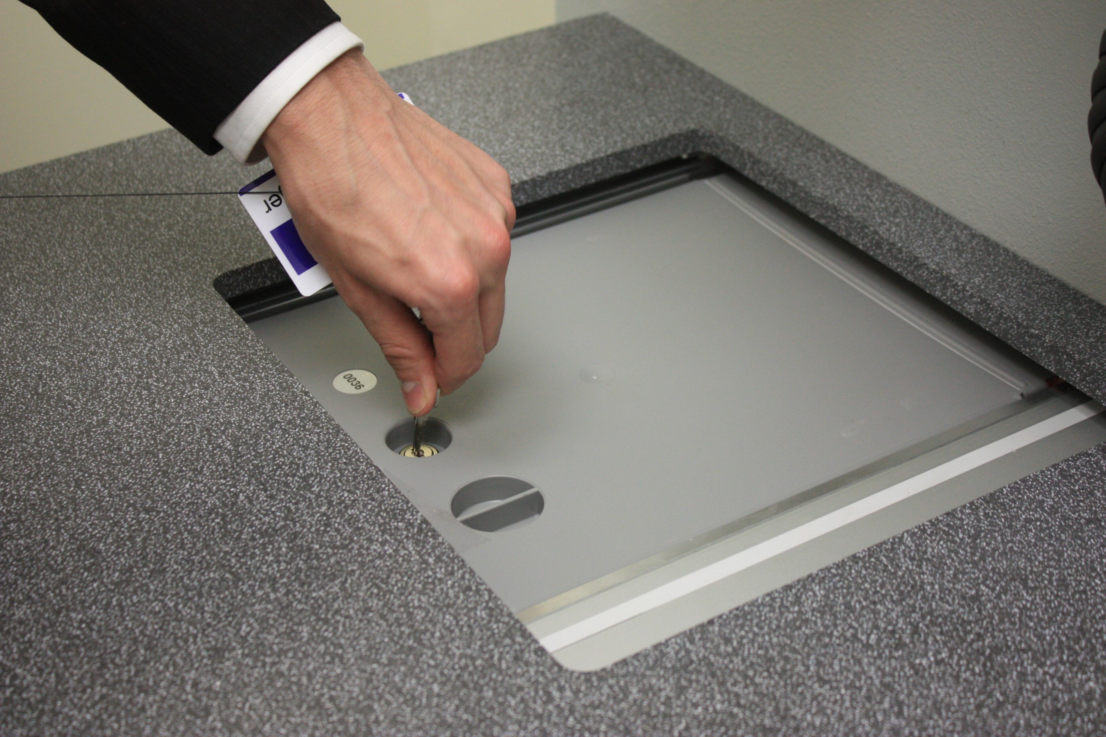 The box is revealed behind a sliding door in the terminal.