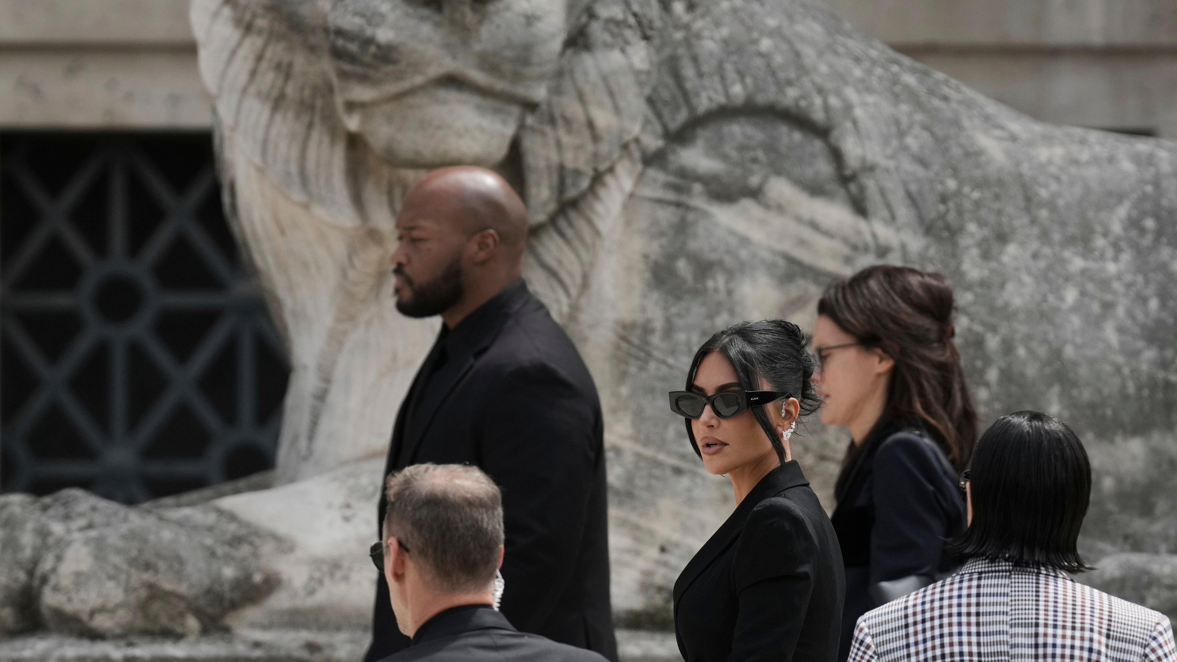 FILE - Kim Kardashian, center, arrives to testify regarding a robbery of millions of dollars in jewels from her Paris hotel room in 2016, in Paris on May 13, 2025. (AP Photo/Aurelien Morissard, File)