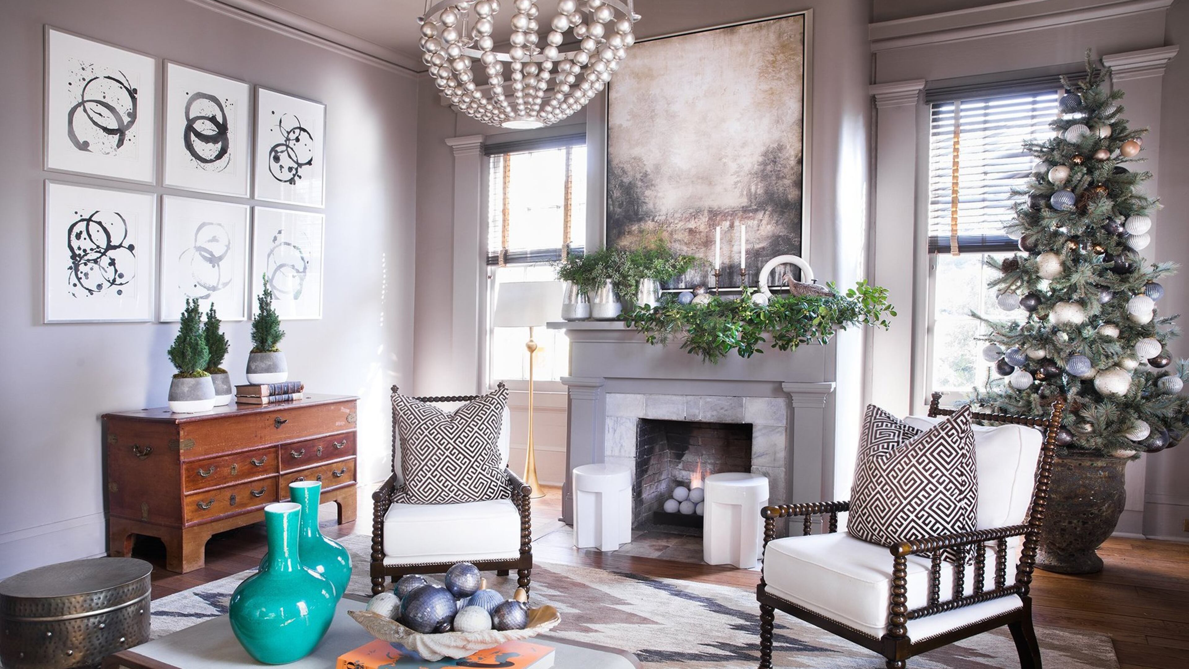 A Christmas tree in an urn, foliage displayed in various ways on the mantel and monochromatic ornaments show Jimmy Stanton’s holiday style in his Madison home. CONTRIBUTED BY Jeff Roffman Photography