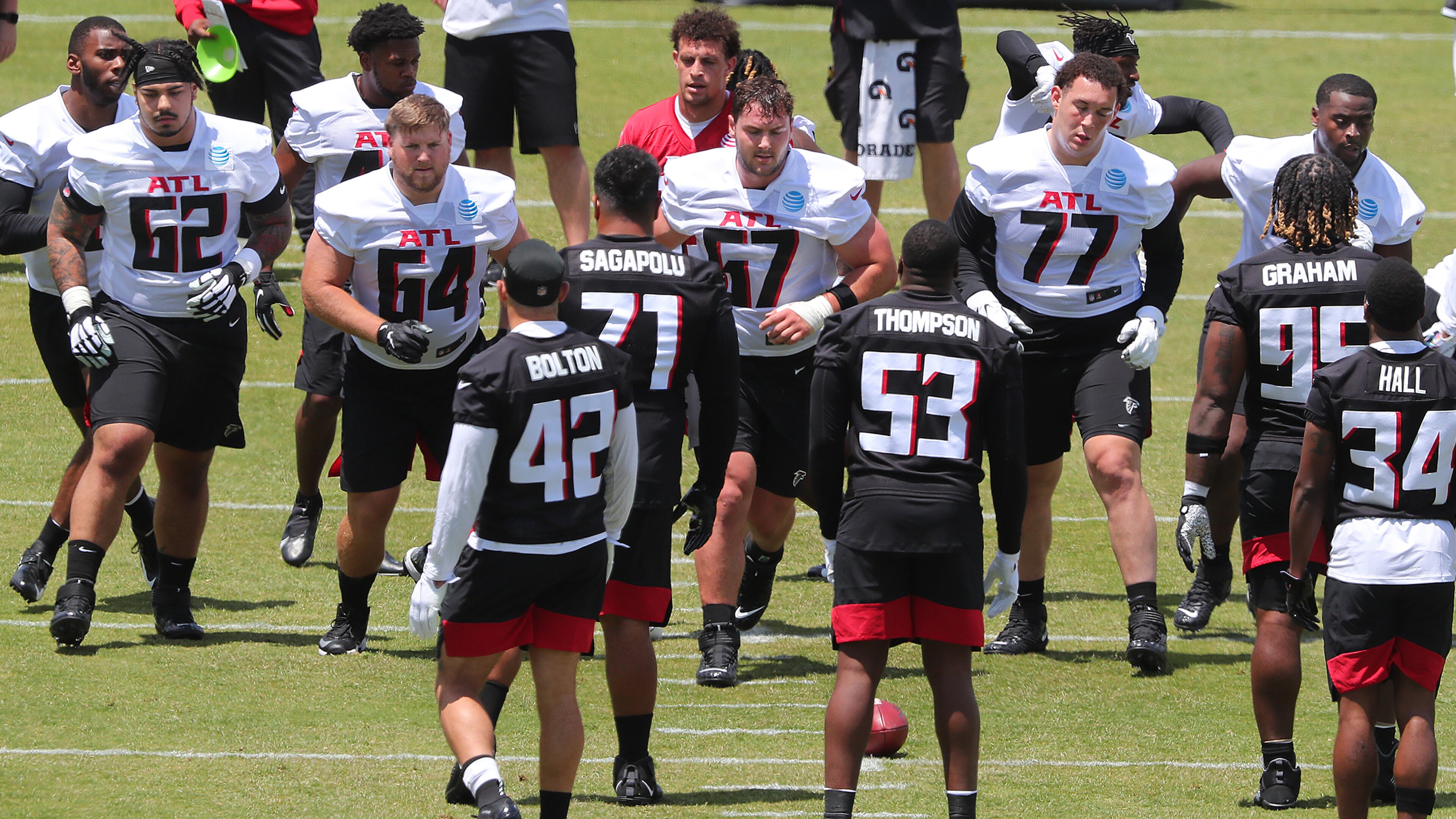 Falcons offensive lineman Bryce Hargrove (from left), Ryan Neuzil, Drew Dalman, Jalen Mayfield and tight end Kyle Pitts line up against the defense to run a play during rookie minicamp Friday, May 14, 2021, in Flowery Branch. (Curtis Compton / Curtis.Compton@ajc.com)