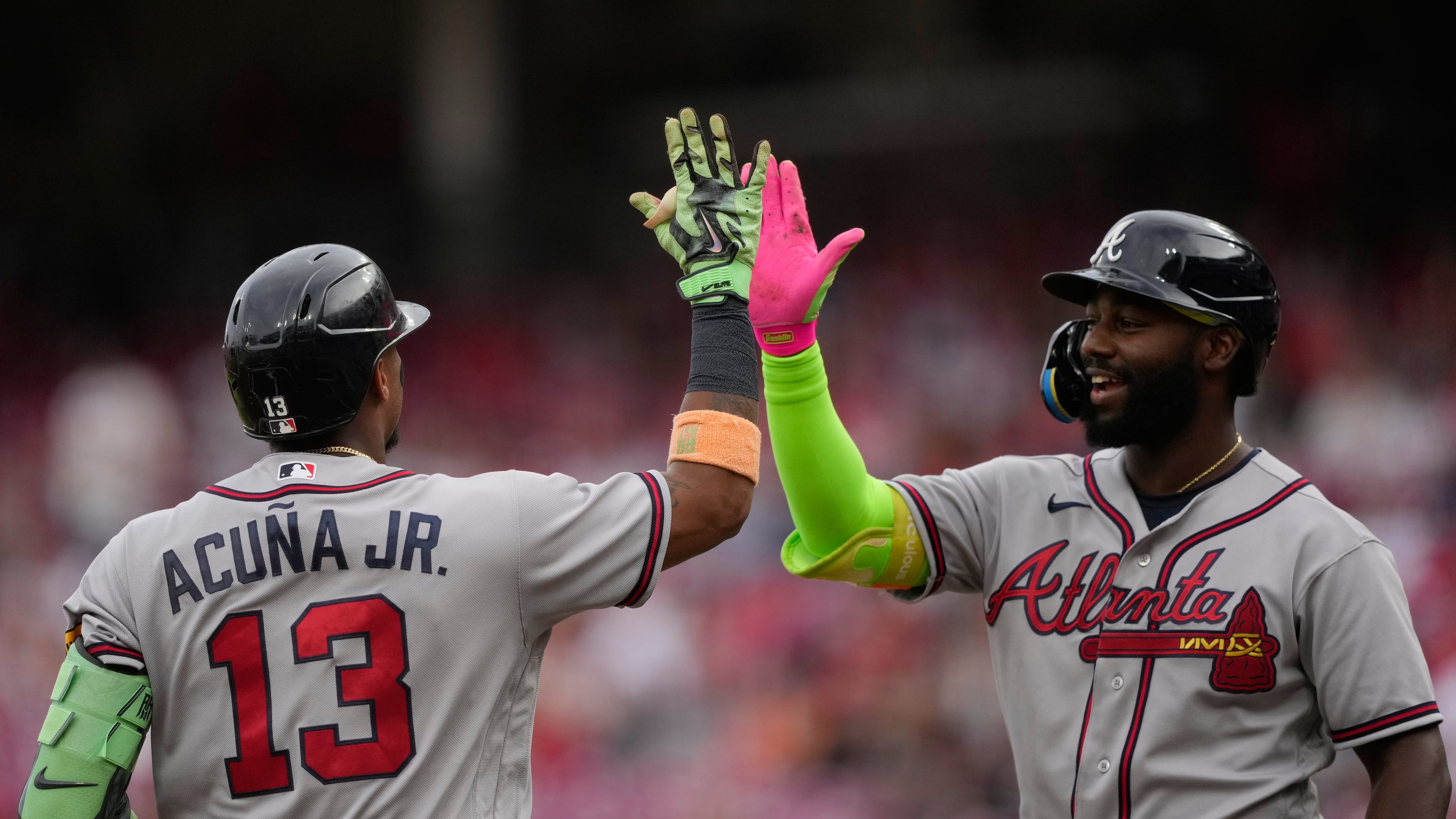 Atlanta Braves' Ronald Acuña Jr. left, celebrates after hitting a solo home run with Michael Harris II, right, during the first inning of a baseball game against the Cincinnati Reds in Cincinnati, Friday, May 29, 2026. (AP Photo/Carolyn Kaster)