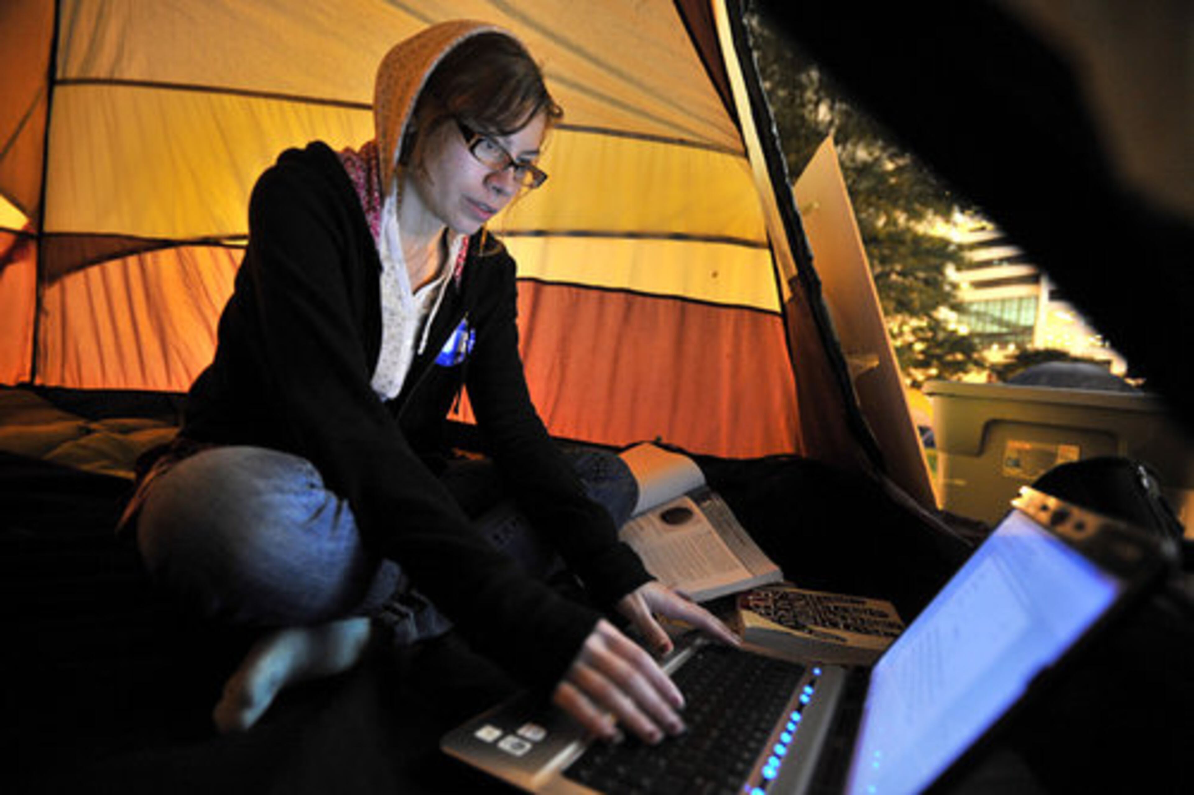 Occupy Atlanta participant Kimlee Davis, who is a freshmen at Georgia State University, does her homework at her friend's tent where she planned to stay overnight Thursday.