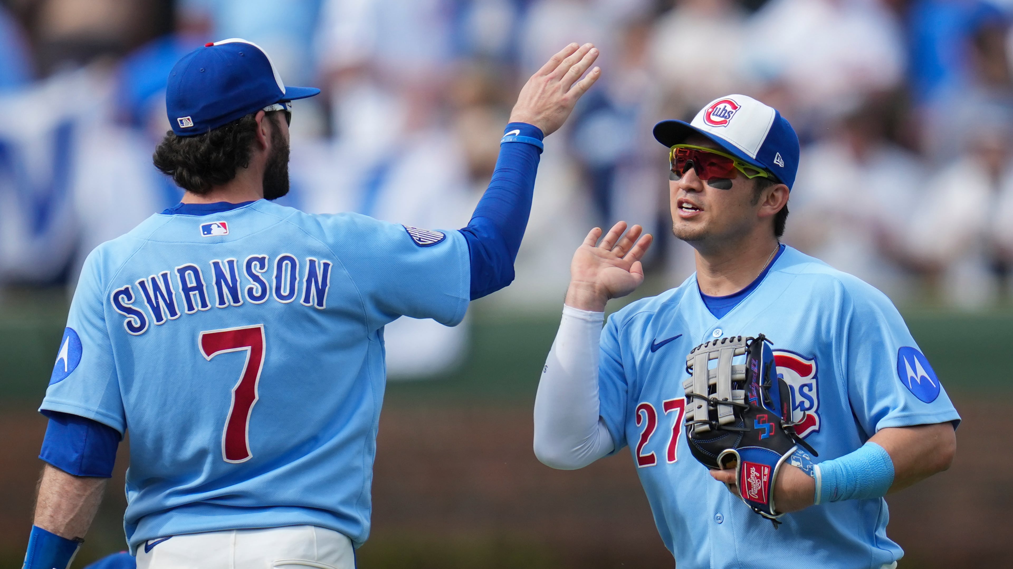 Chicago Cubs' Dansby Swanson (7) and Seiya Suzuki (27) celebrate their team's win over the New York Mets in a baseball game Friday, April 17, 2026, in Chicago. (AP Photo/Erin Hooley)