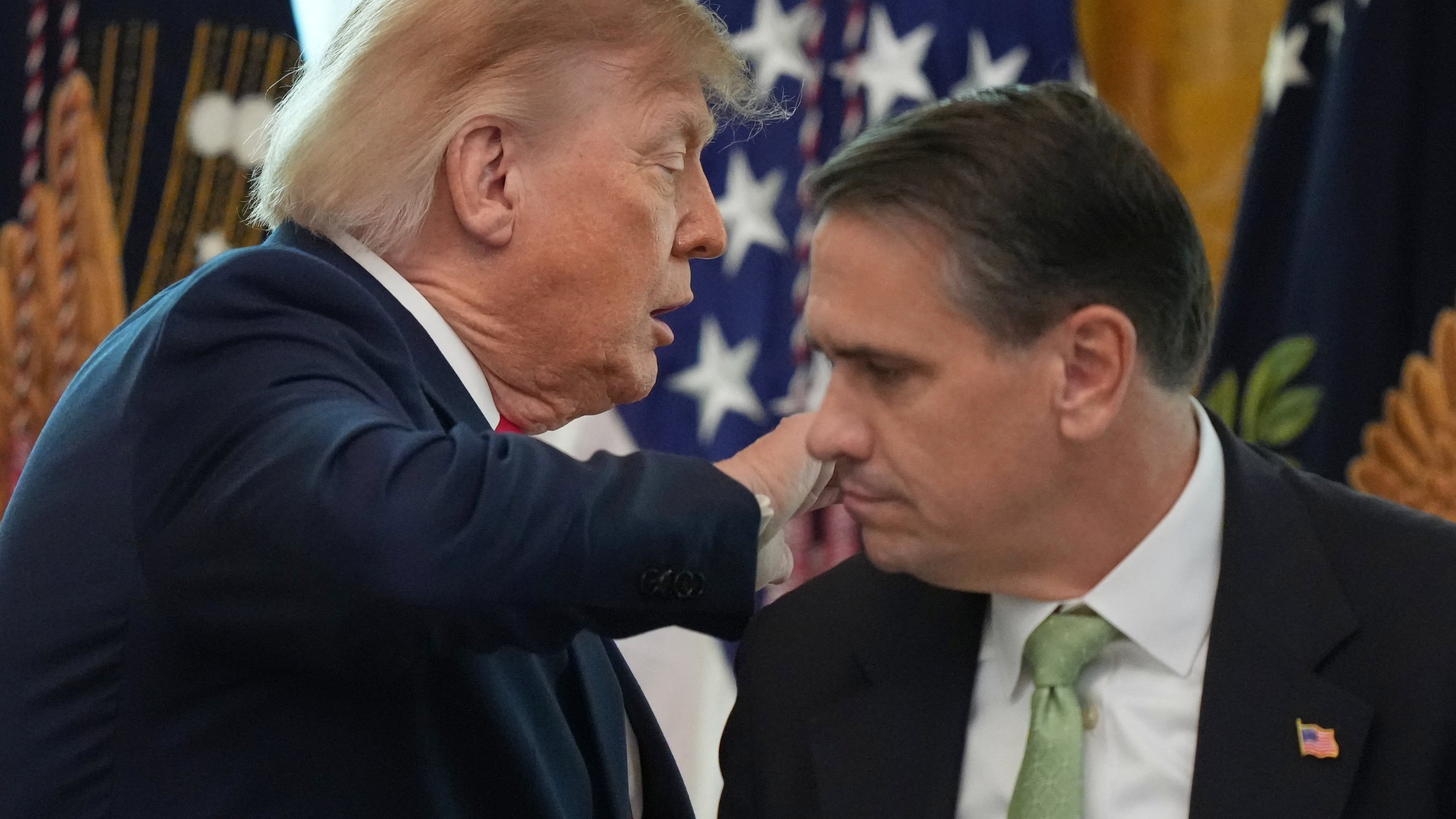 President Donald Trump walks past Attorney General Todd Blanche after speaking at a roundtable event in the East Room of the White House, Wednesday, Oct. 21, 2026, in Washington. (AP Photo/Alex Brandon)