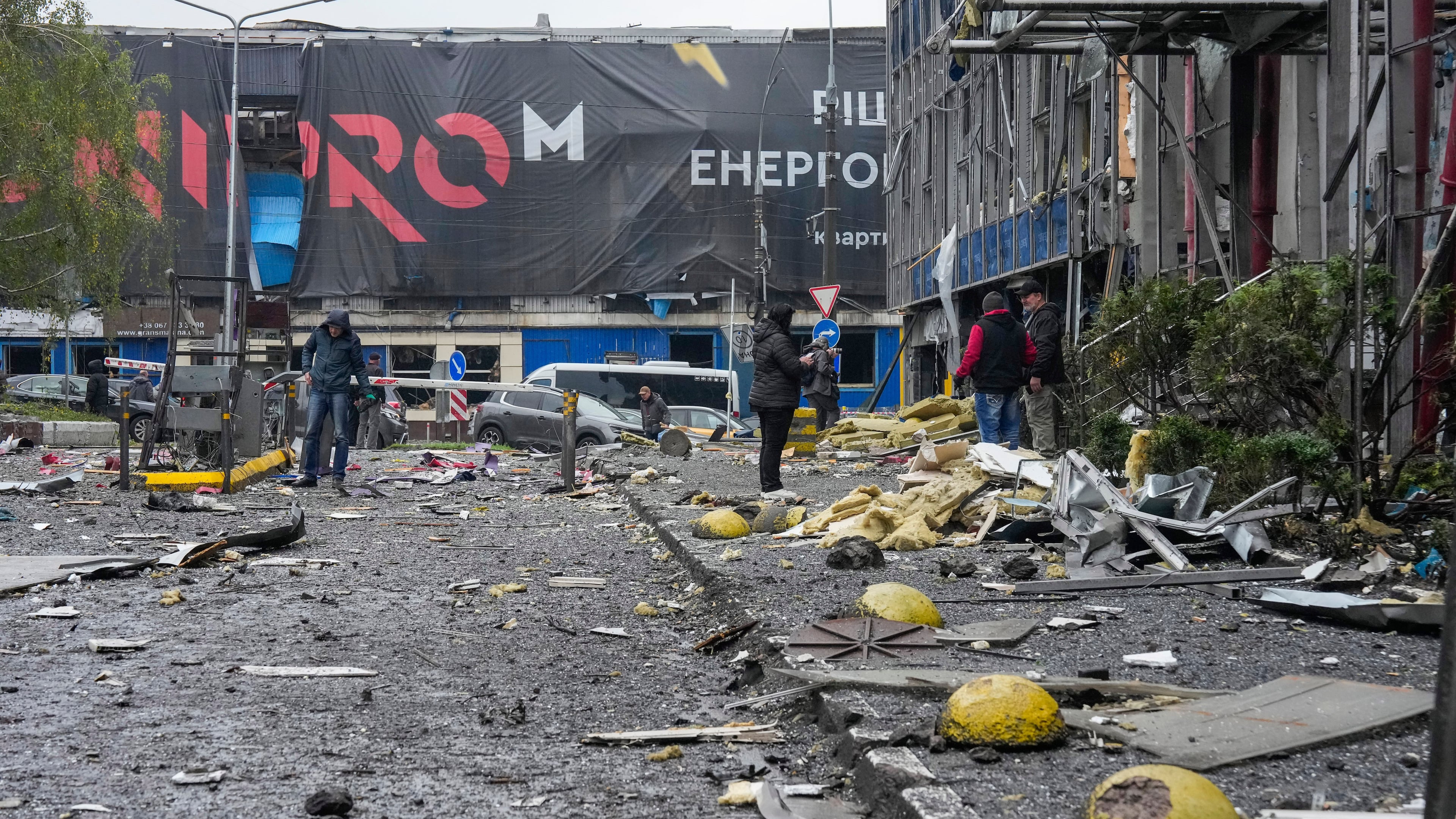 People look at damaged office center after a Russian missile attack in central Kyiv, Ukraine, Monday, Oct. 19, 2026. (AP Photo/Efrem Lukatsky)