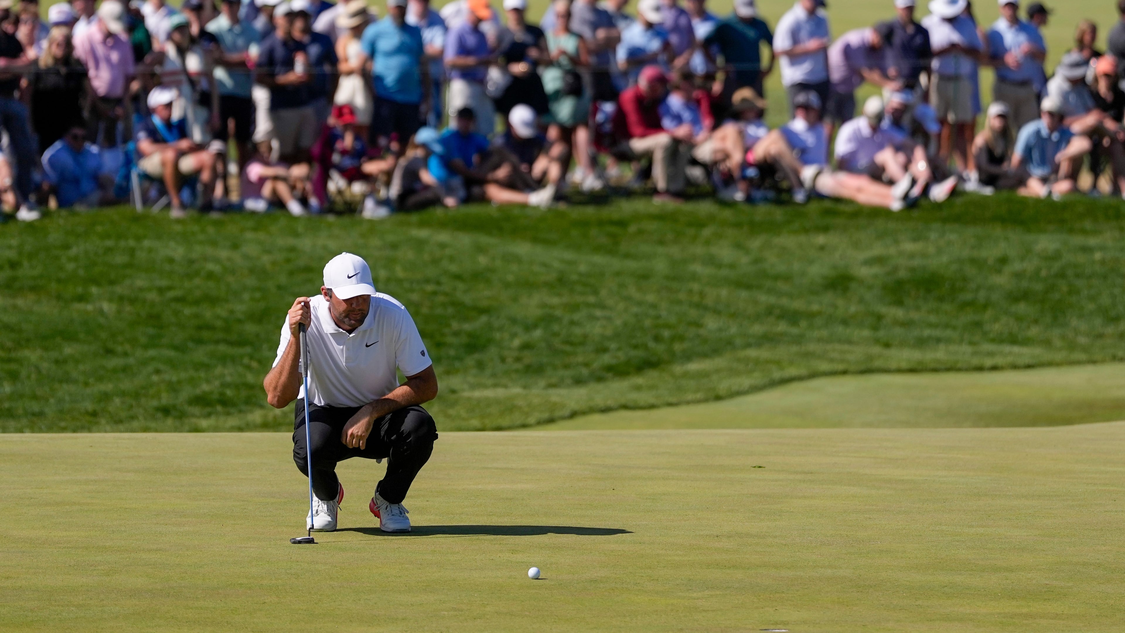 Scottie Scheffler lines up his shot on the 10th green during the third round of the PGA Championship golf tournament at Aronimink Golf Club, Saturday, May 16, 2026, in Newtown Square, PA. (AP Photo/Matt Slocum)
