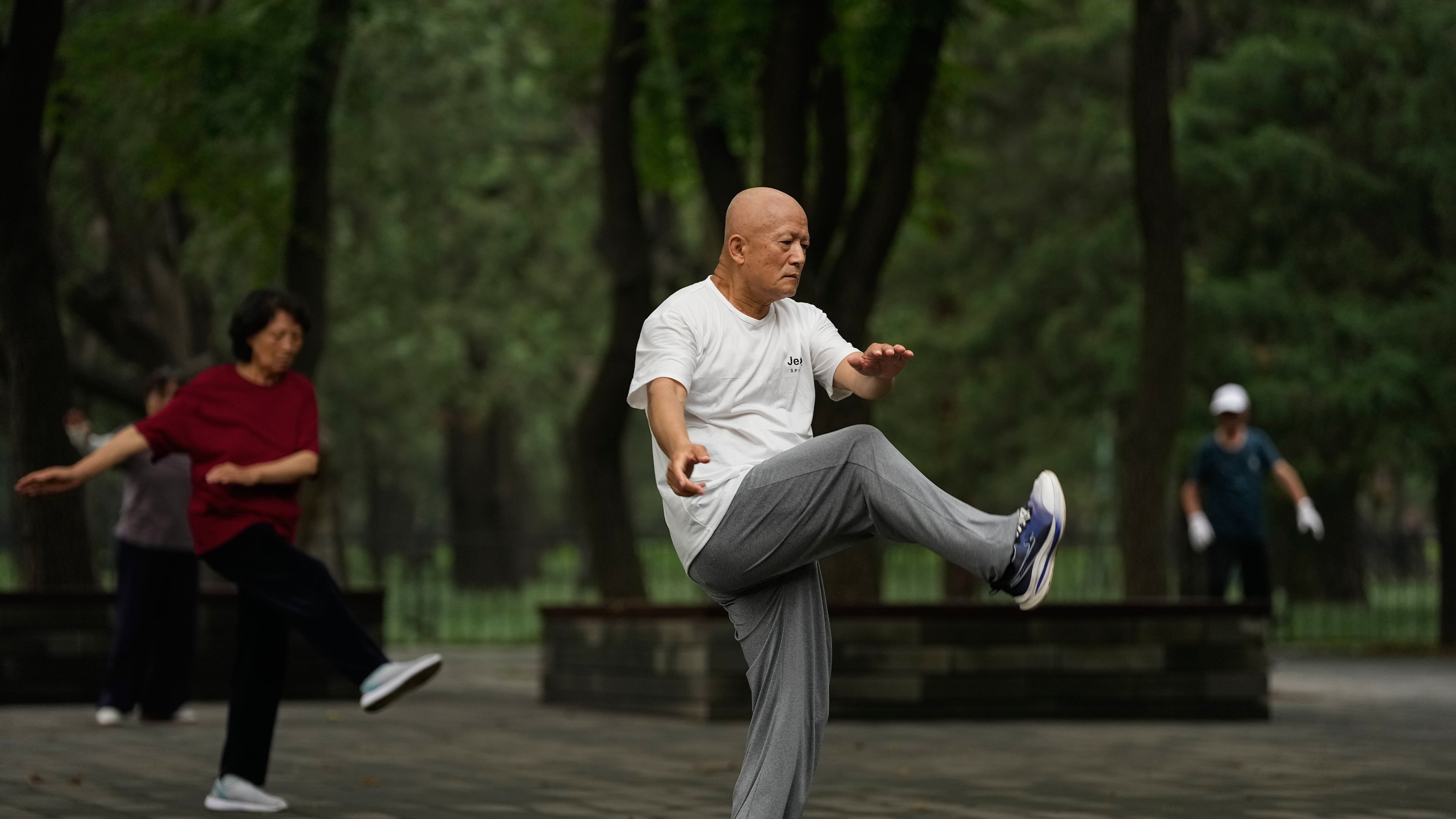 People practice Tai Chi at a park near the Temple of Heaven in Beijing, Thursday July 9, 2026. (AP Photo/Andy Wong)