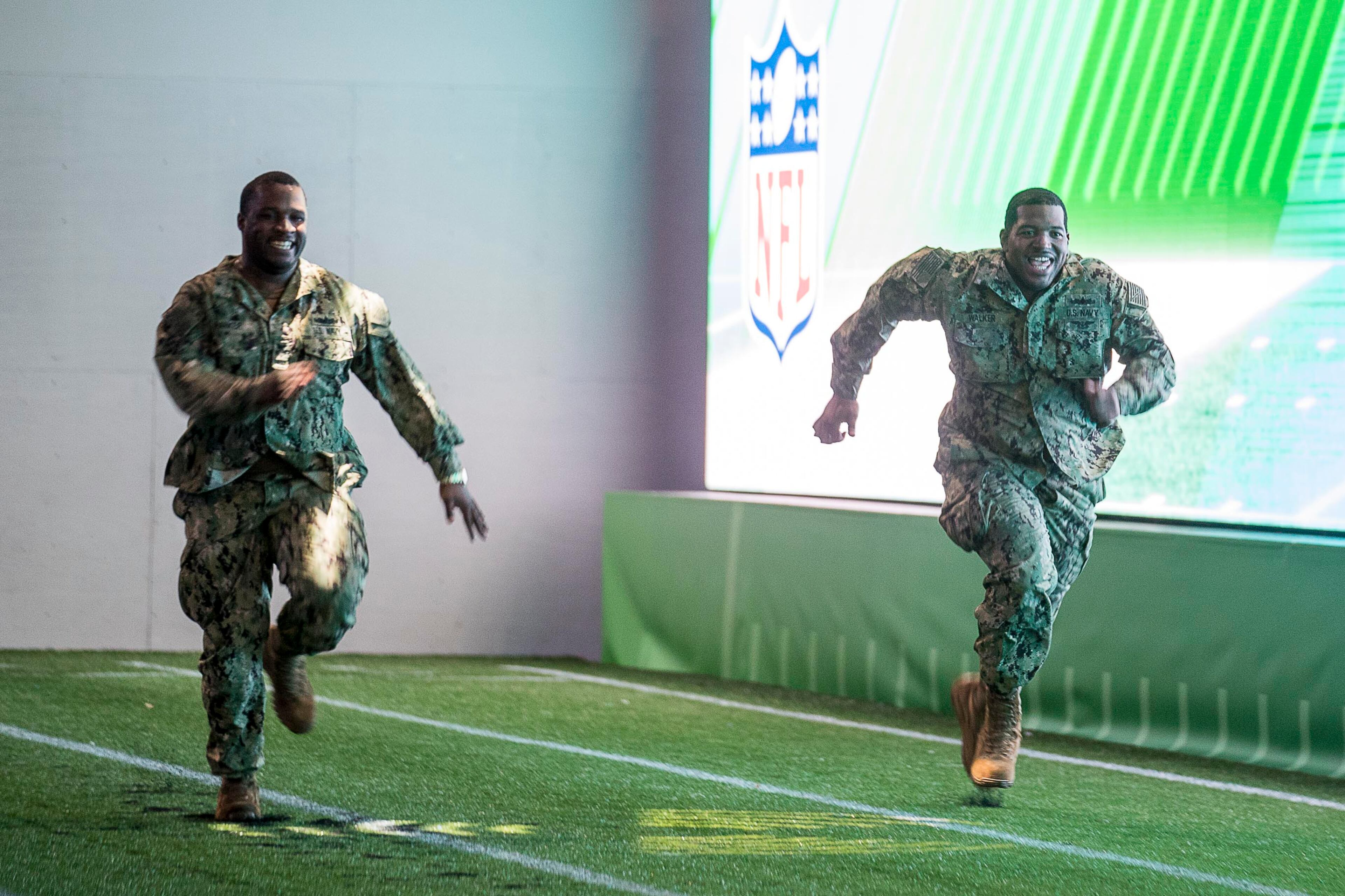 U.S. Navy Petty Officer first class Dchuan Parker (left) competes in a race with U.S. Navy Petty Officer second class Michael Walker during the Super Bowl LIII Fan experience Salute to Military day at the Georgia World Congress Center in Atlanta, Monday, January 28, 2019.
