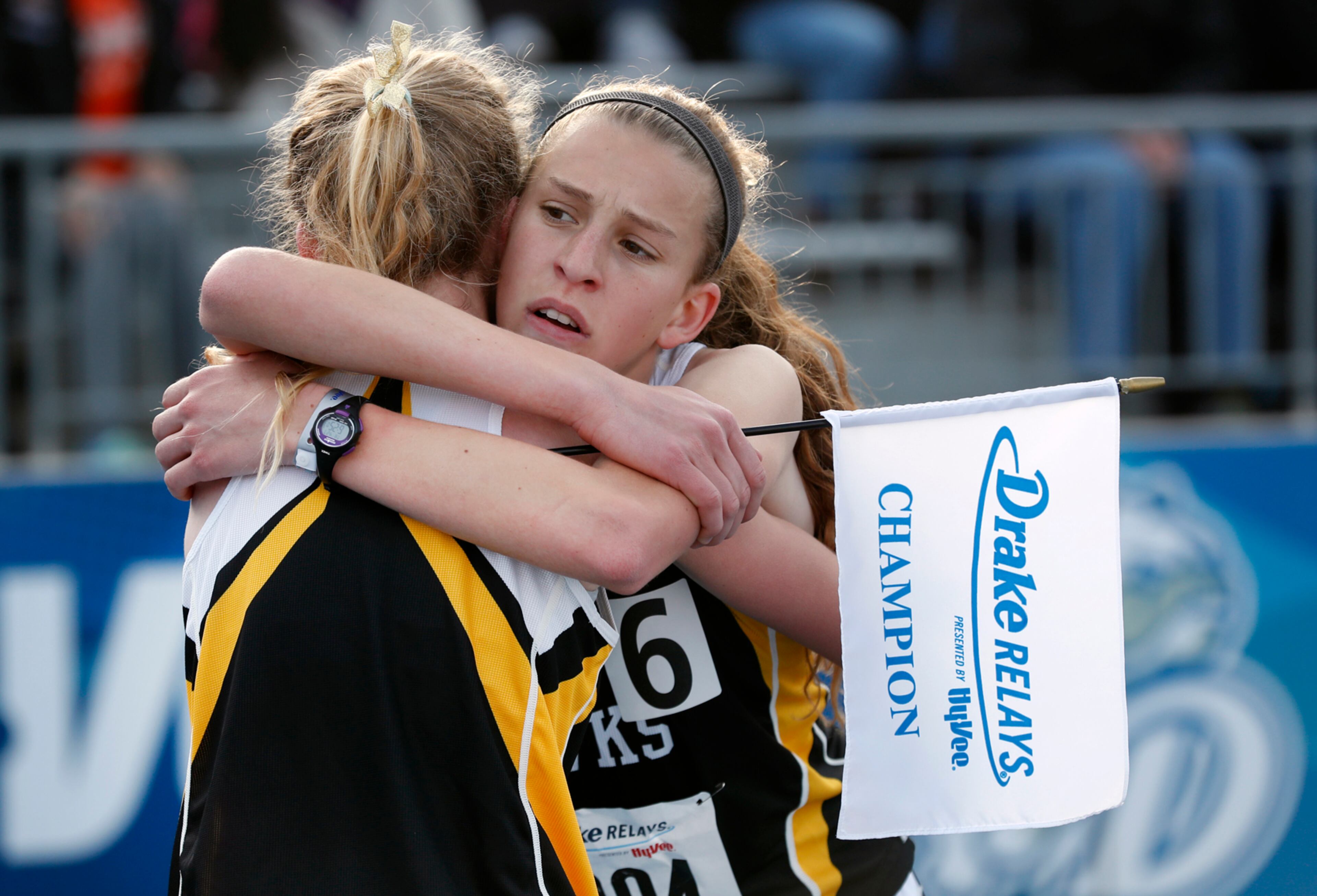 Mid-Prairie's Anna Hostetler, right, gets a hug from her sister Marie, left, after winning the high school girls' 3,000 meters at the Drake Relays athletics meet, Thursday, April 27, 2017, in Des Moines, Iowa. (AP Photo/Charlie Neibergall)
