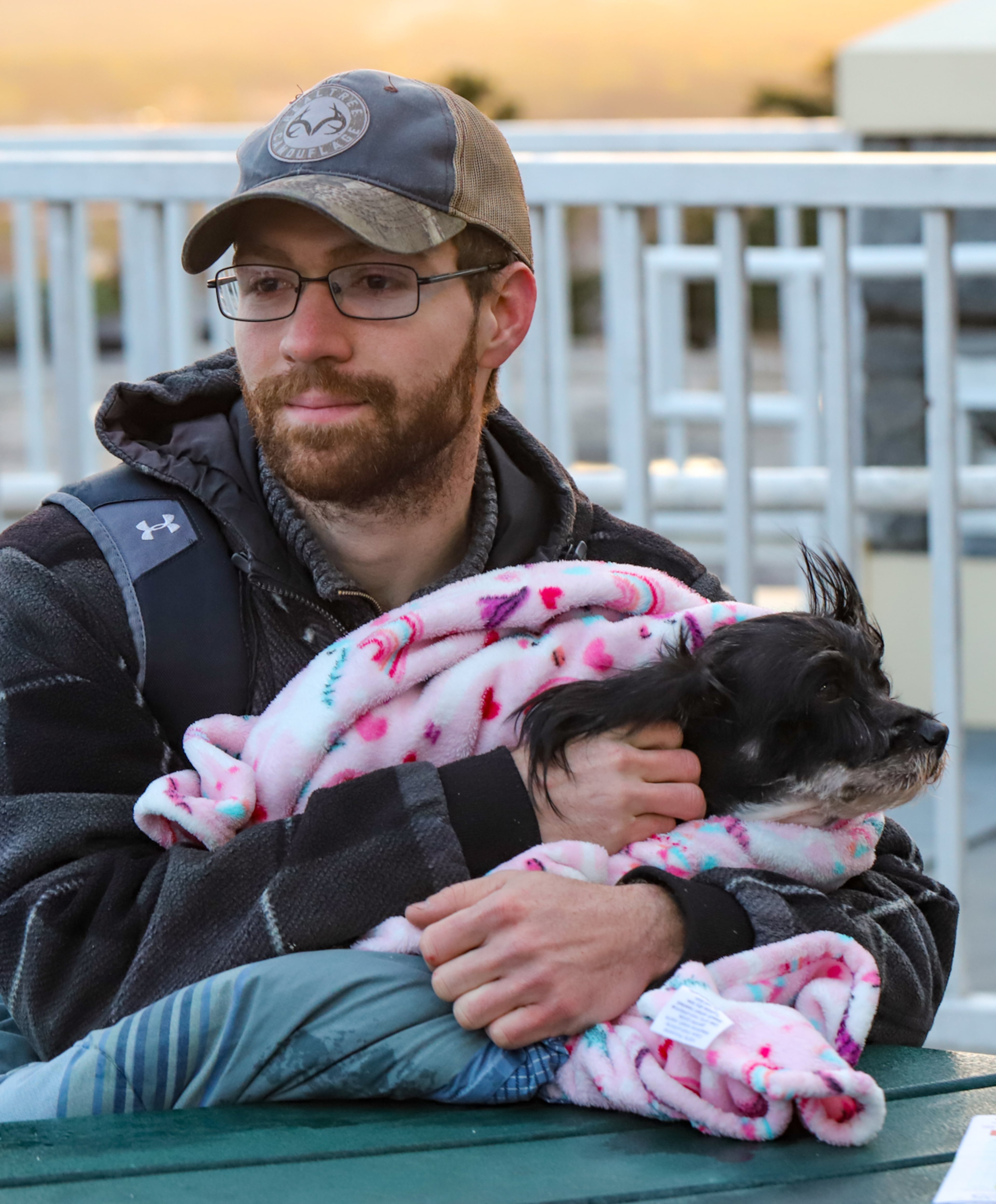 Worshippers, including Christopher Baker and his Yorkshire terrier Jack, gather atop Stone Mountain for the annual Easter sunrise service despite 40 degree weather and 25 mph winds Sunday, April 9, 2023. (Photo: Jenni Girtman for The Atlanta Journal-Constitution)
