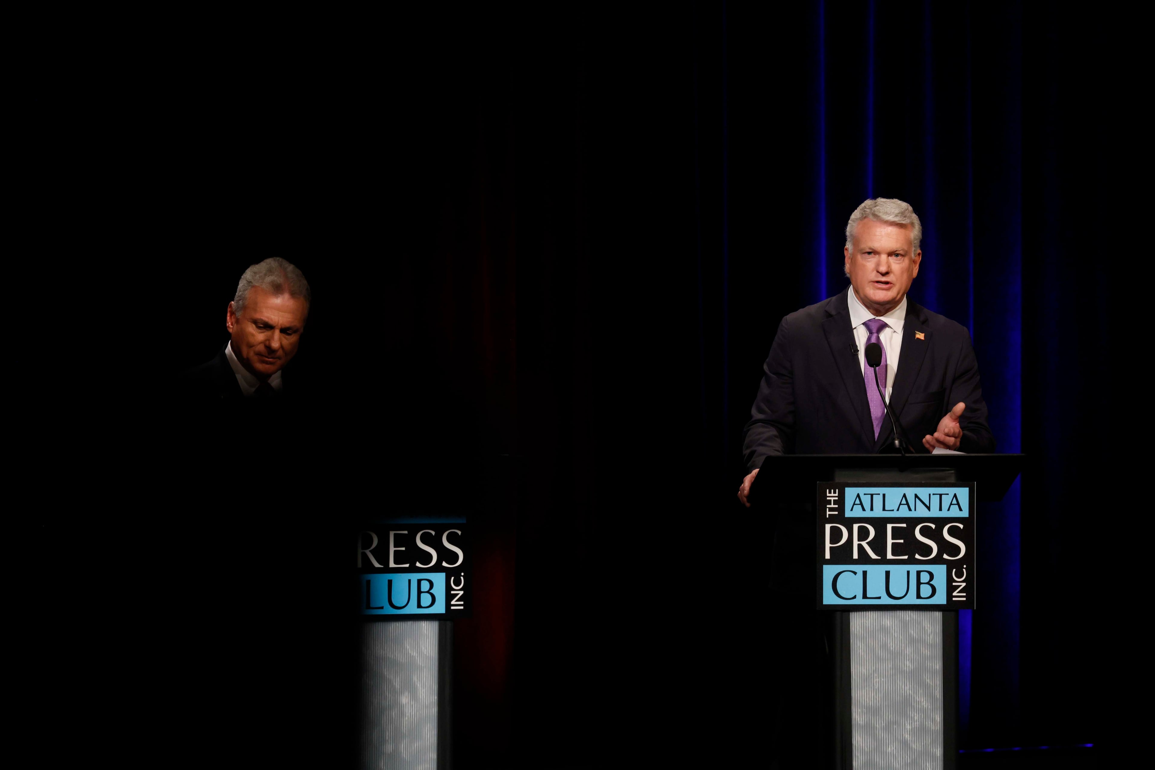 U.S. Rep. Mike Collins, R-Jackson, right, responds to a question at the Atlanta Press Club Loudermilk-Young debate for the U.S. Senate at Georgia Public Broadcasting in Midtown on Sunday, April 26, 2026. (Miguel Martinez/AJC)