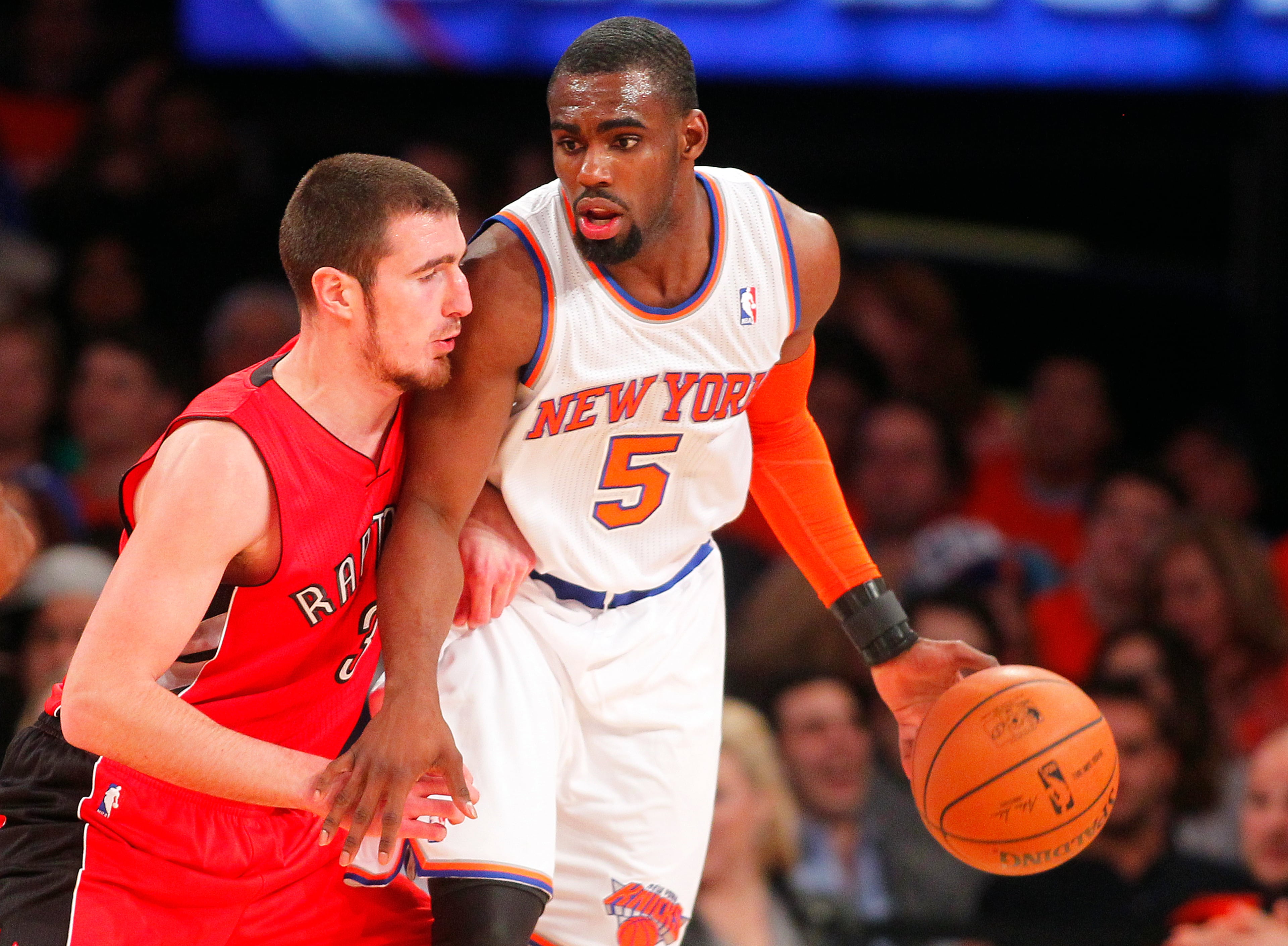 Tim Hardaway Jr. #5 of the New York Knicks is defended by Greivis Vasquez #21 of the Toronto Raptors in the first half during an NBA basketball game at Madison Square Garden on April. 16, 2014 in New York City. The Knicks defeated the Raptors 95-92. (Photo by Getty Images)