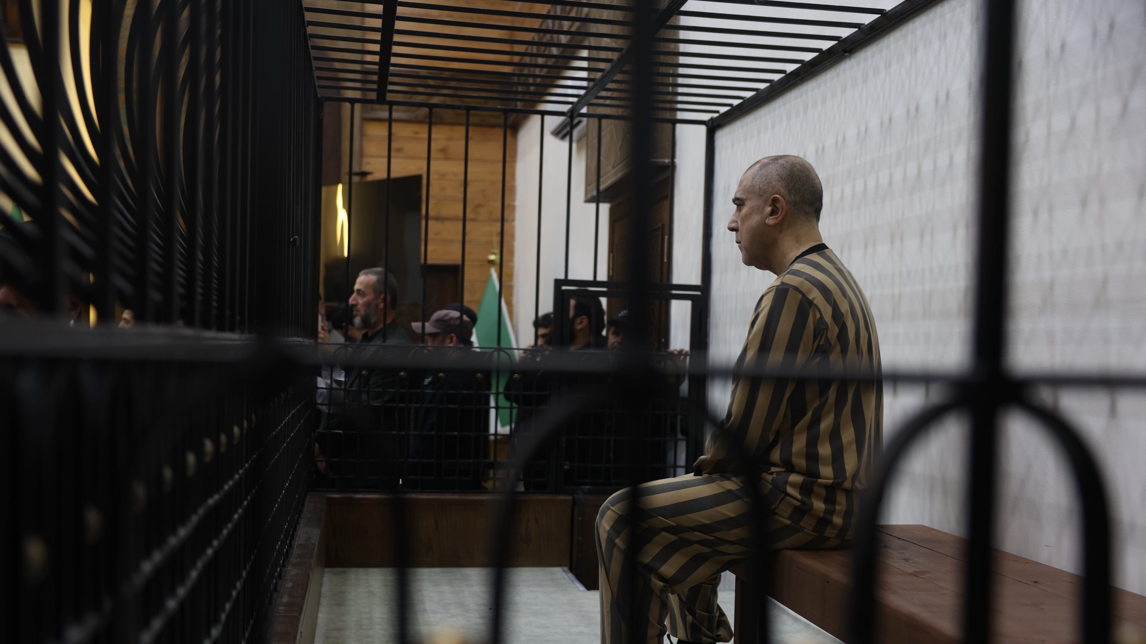 Atef Najib, former head of the Political Security Branch in the Daraa area during Bashar Assad's rule, sits in the defendants' cage during a trial session at the Palace of Justice in Damascus, Syria, Sunday, April 26, 2026. (AP Photo/Ghaith Alsayed)
