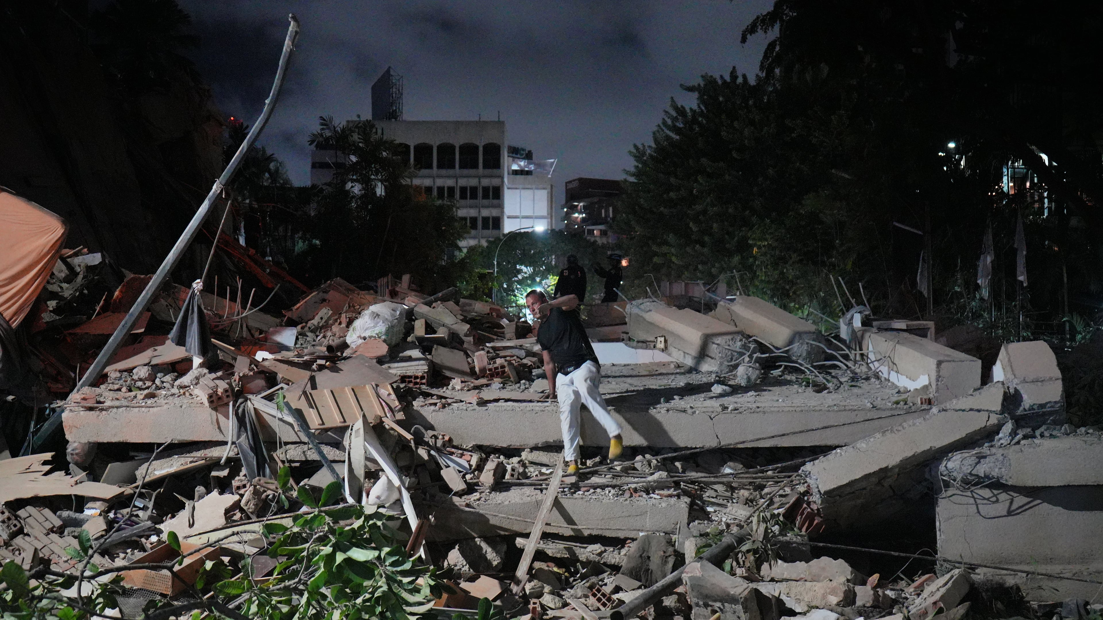 A man jumps on a collapsed building after an earthquake in Caracas, Venezuela, Wednesday, June 24, 2026. (AP Photo/Adrian Naranjo)