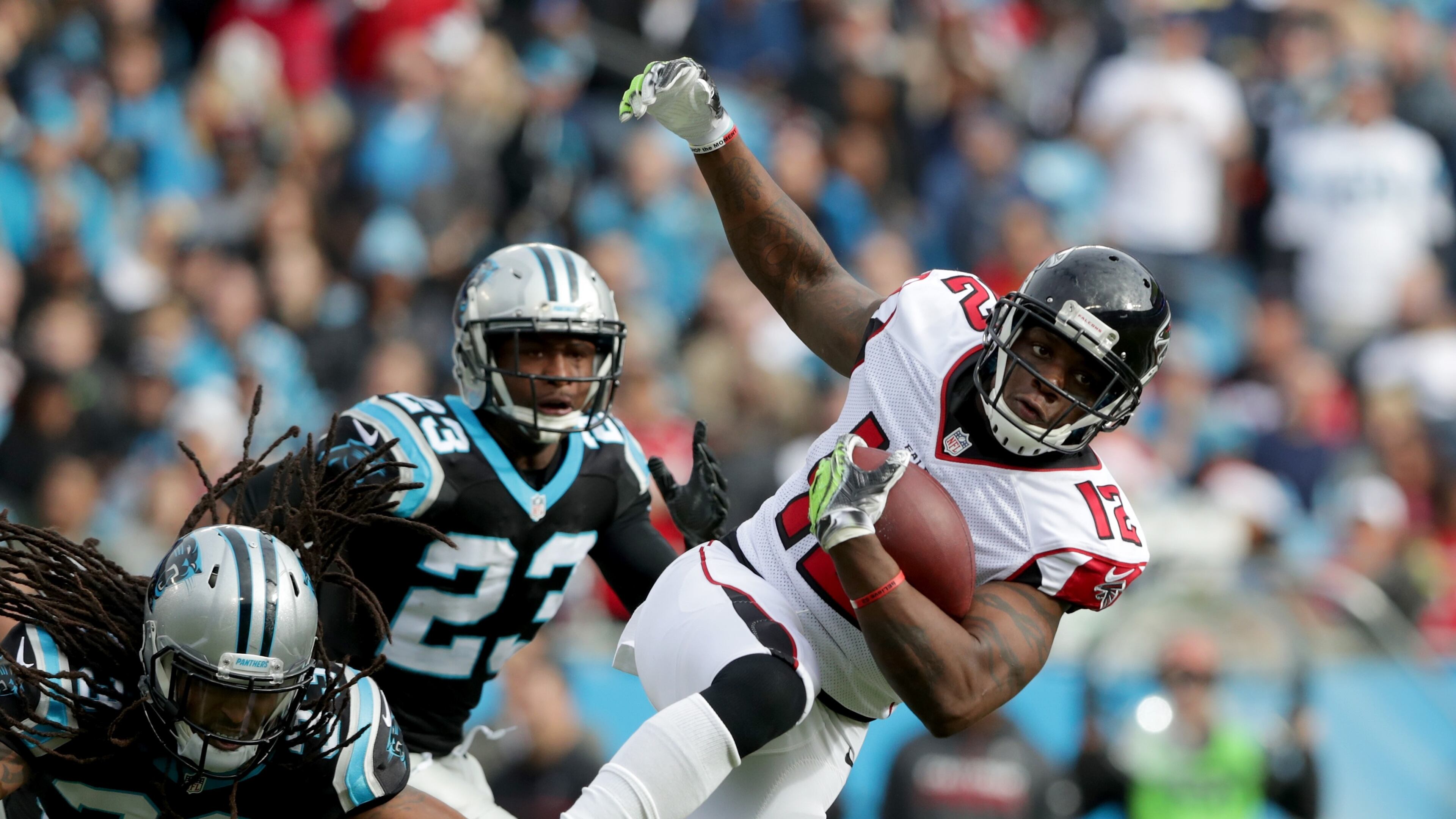 The Falcons’ Mohamed Sanu runs after a catch against Tre Boston (33) and Leonard Johnson of the Panthers in the second quarter during their game at Bank of America Stadium on Dec. 24, 2016 in Charlotte, N.C. (Photo by Streeter Lecka/Getty Images)