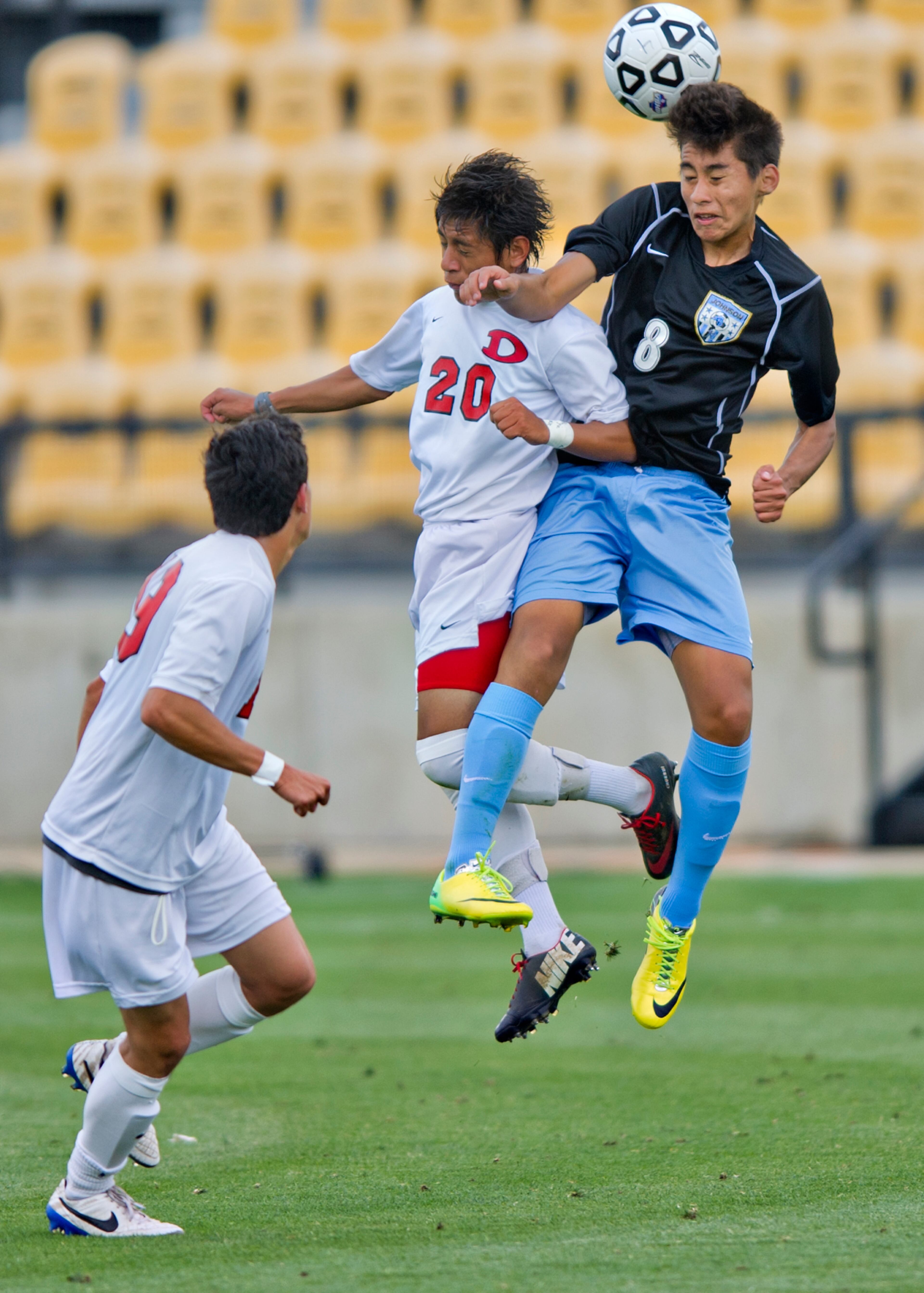 Dalton's Churrui Huitanda (20) and Johnson's Bryant Anaya (8) compete for control of the ball in mid air during the Class AAAA championship soccer game at Kennesaw State University on Saturday, May 17, 2014.