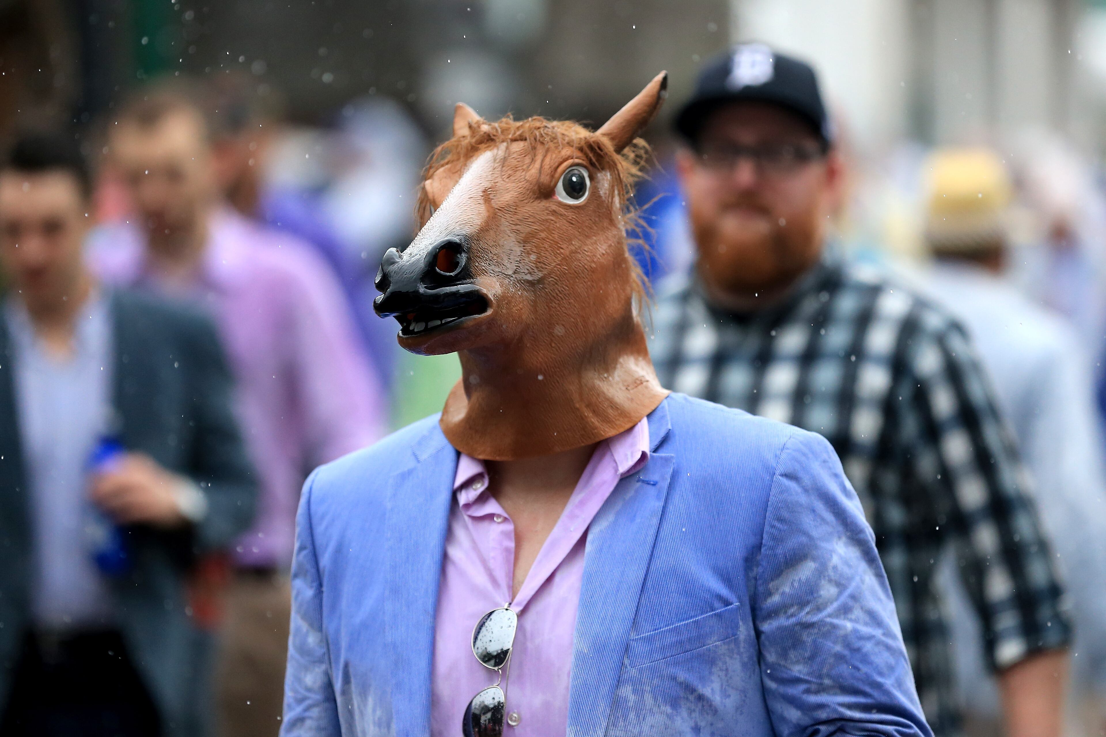 LOUISVILLE, KY - MAY 05: A race fan with a horse mask looks on prior to the 144th running of the Kentucky Derby at Churchill Downs on May 5, 2018 in Louisville, Kentucky. (Photo by Sean M. Haffey/Getty Images)