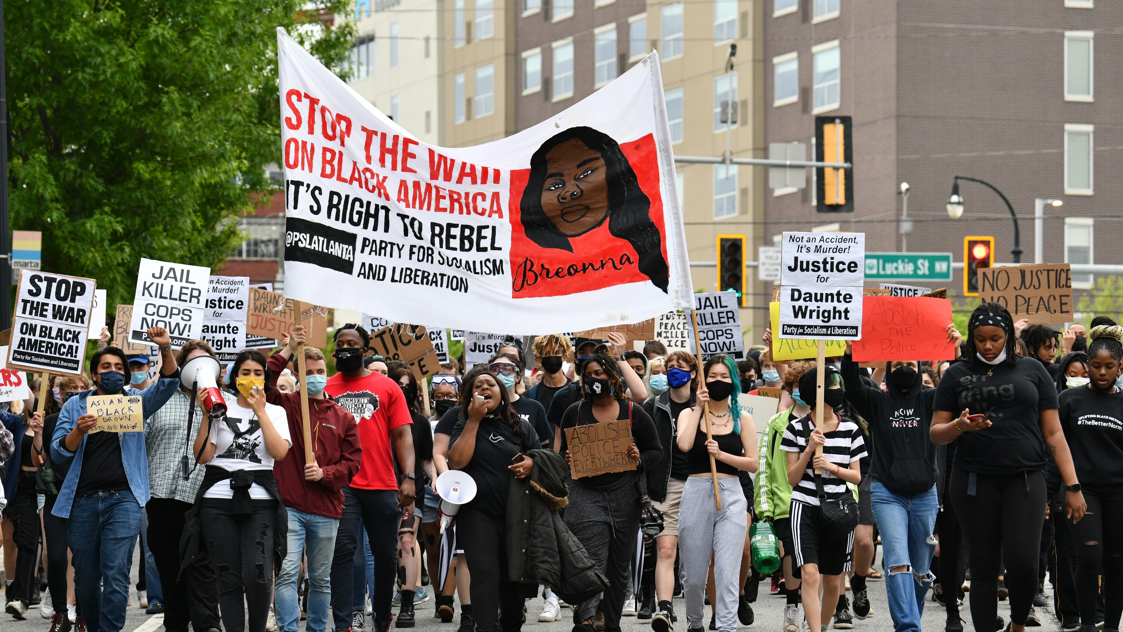 April 14, 2021 Atlanta - Protesters march around the Centennial Olympic Park during a rally in solidarity with Minnesota - Justice for Daunte Wright on Wednesday, April 14, 2021. (Hyosub Shin / Hyosub.Shin@ajc.com)