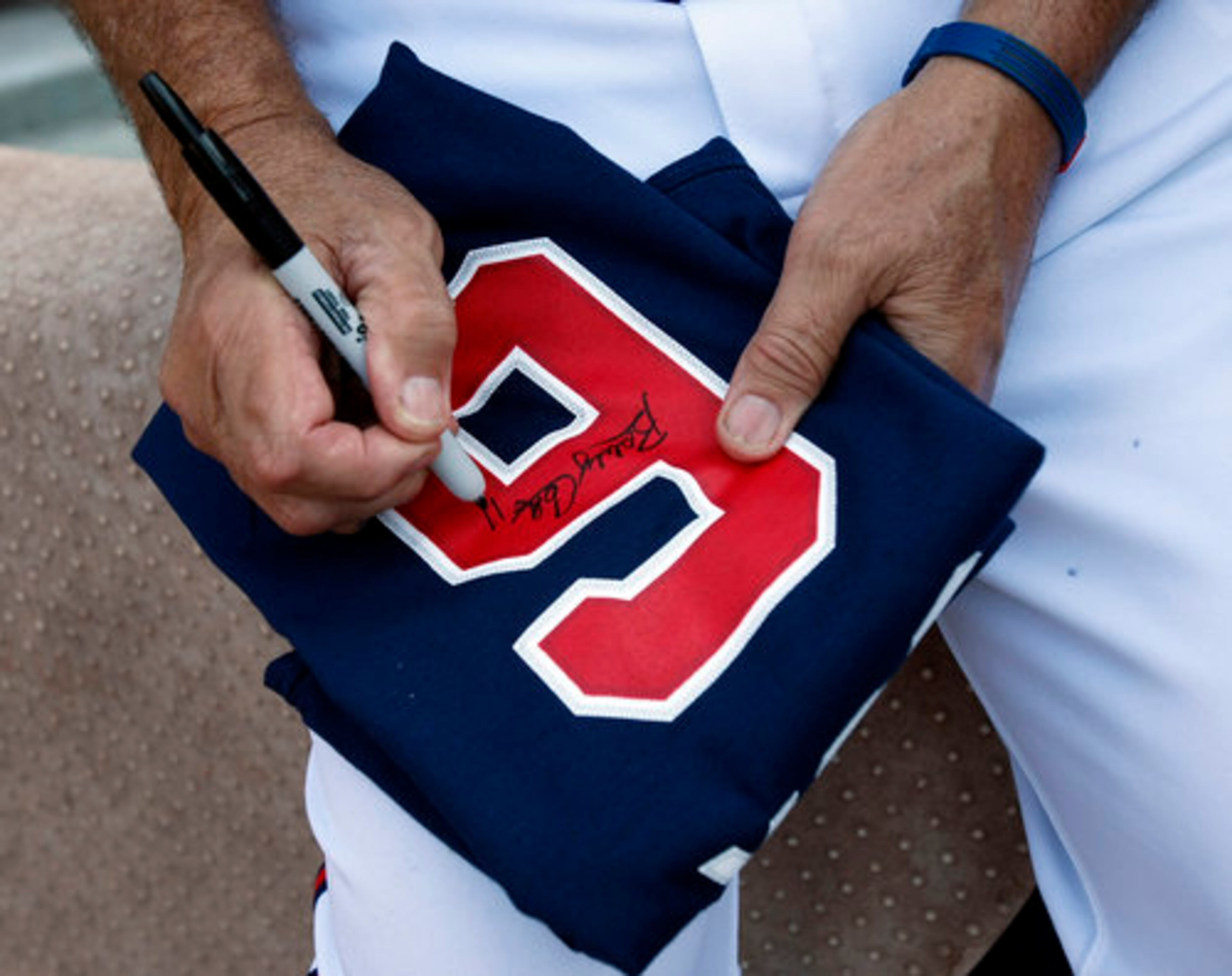 Bobby Cox autographs a # 6 jersey for a fan before taking on the Phillies for the final home stand at Turner Field in Atlanta on Friday, Oct. 1, 2010.