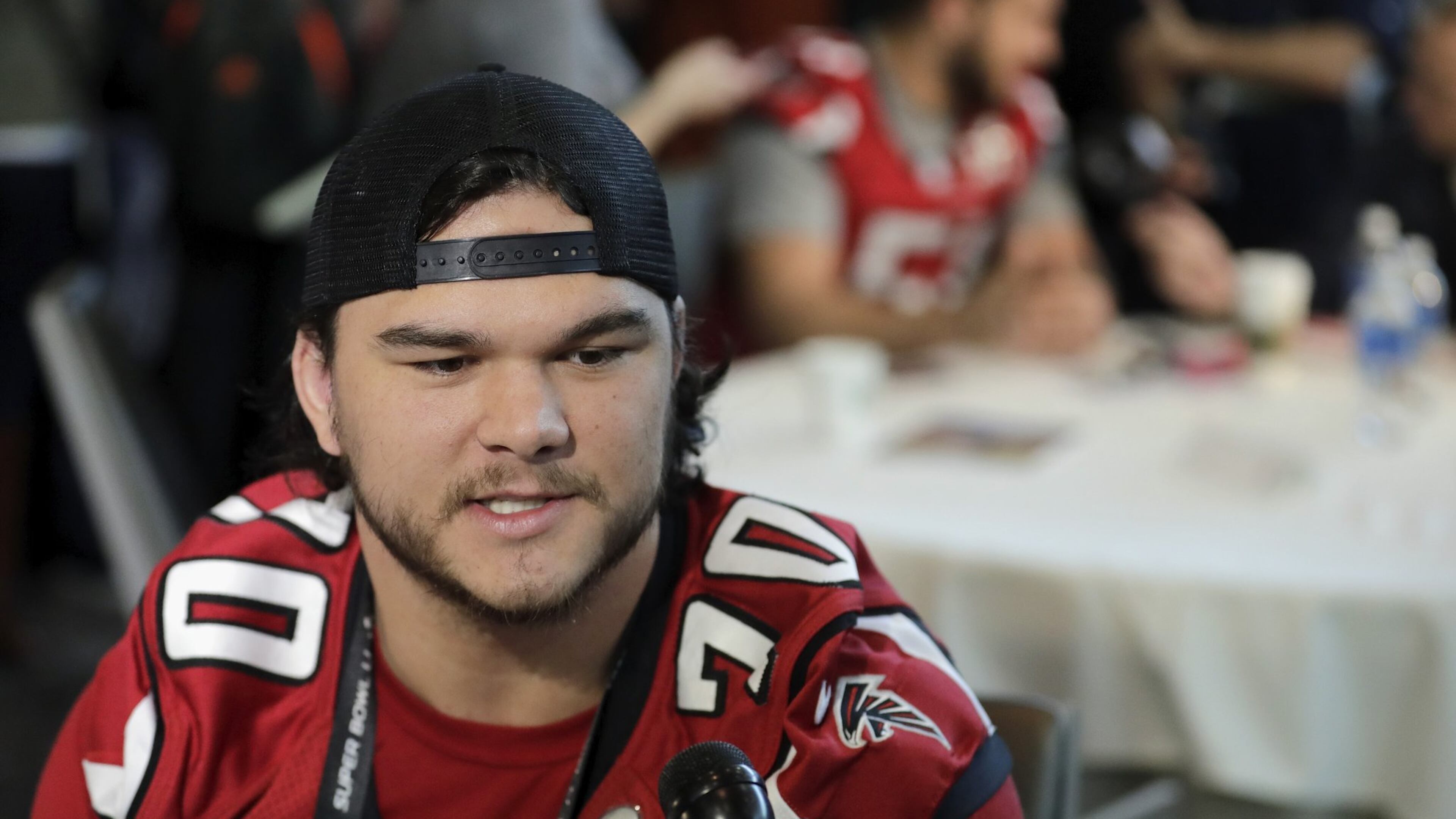 The Falcons Jake Matthews relaxes and enjoys his Super Bowl press gathering Wednesday. (Tim Warner/Getty Images)
