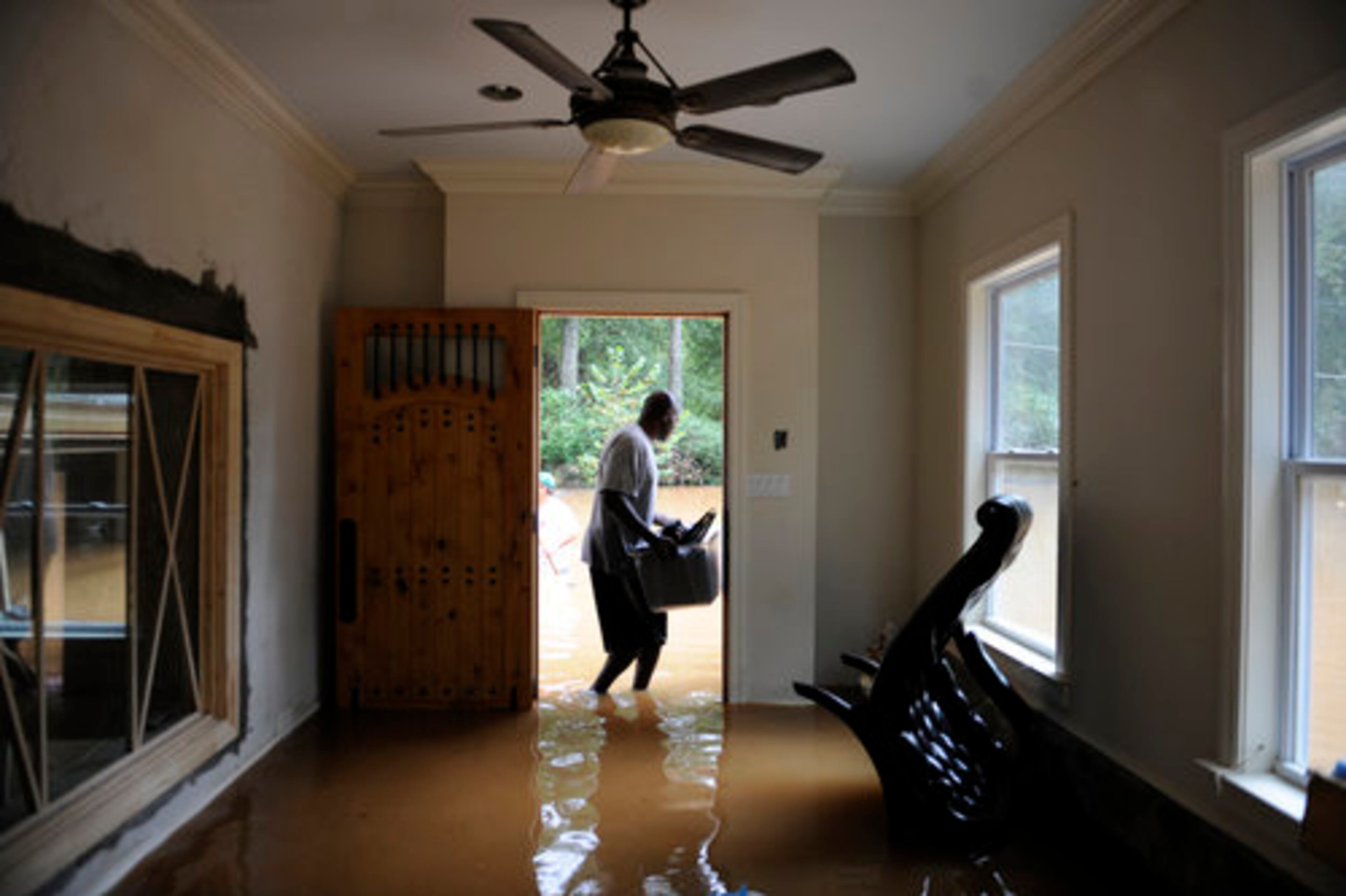 Tanqueray Clark removes some belongings from his Atlanta home. He was being helped by Tony Cameron, a stranger who had once looked at owning Clark's house.