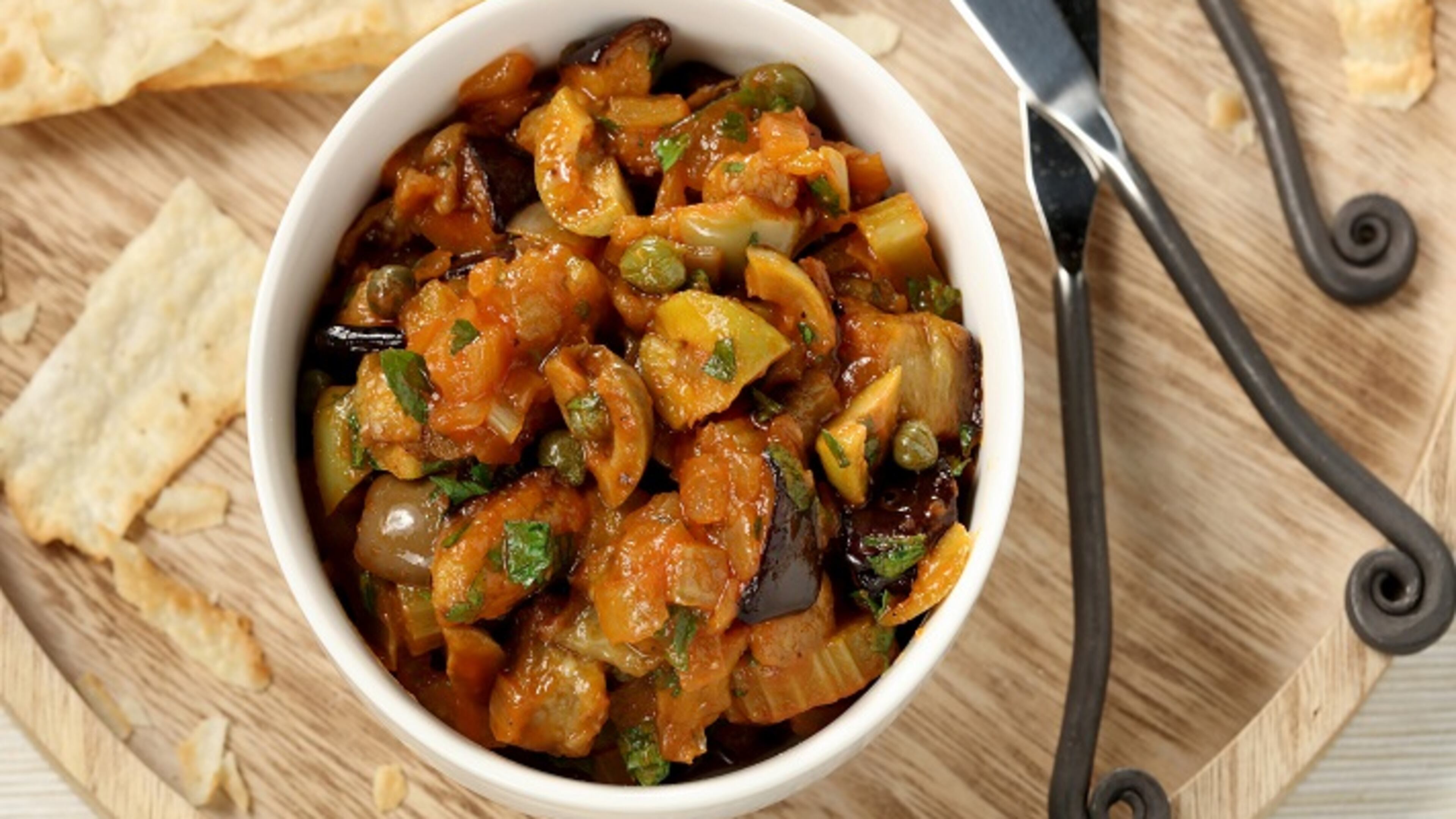 Serve caponata with crackers as an appetizer, topped with poached eggs for breakfast or alongside a protein like chicken for dinner. (Michael Tercha/Chicago Tribune/TNS)