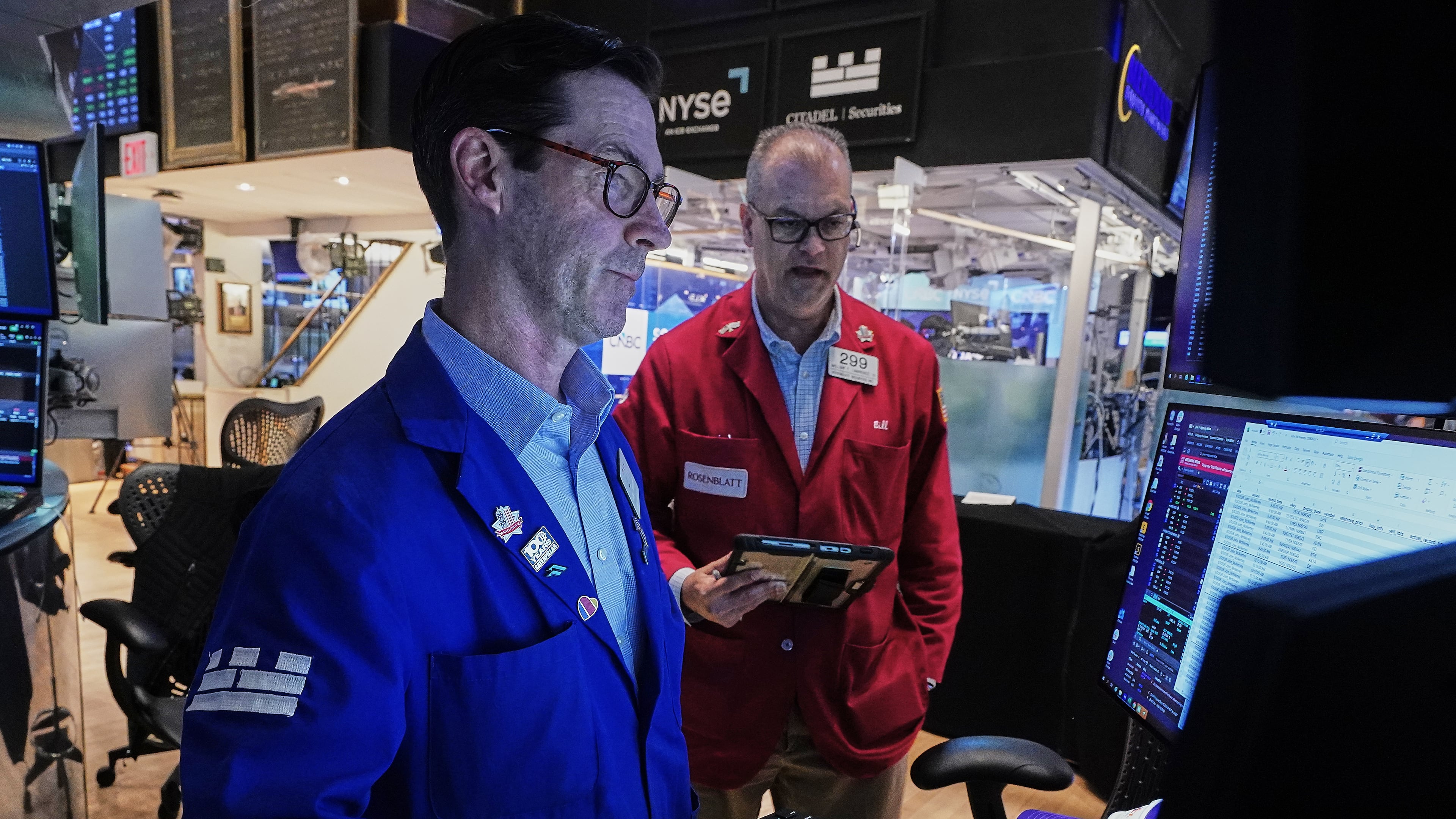 Specialist John McNierney, left, and trader William Lawrence work on the floor of the New York Stock Exchange, Wednesday, June 3, 2026. (AP Photo/Richard Drew)