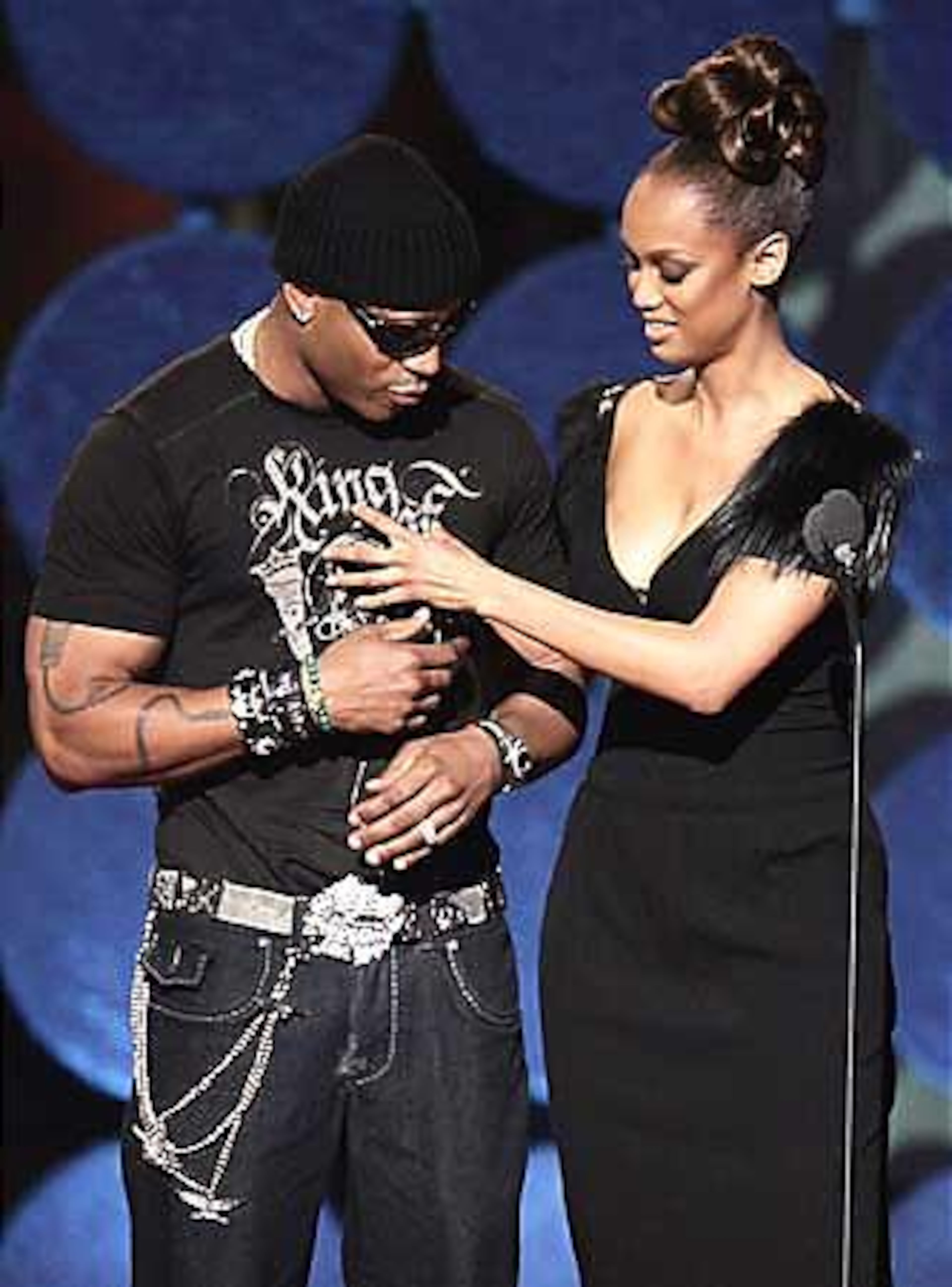 Hip-Hop artist L.L. Cool J and model Tyra Banks appear on stage at Conde Nast's Fashion Rocks concert.