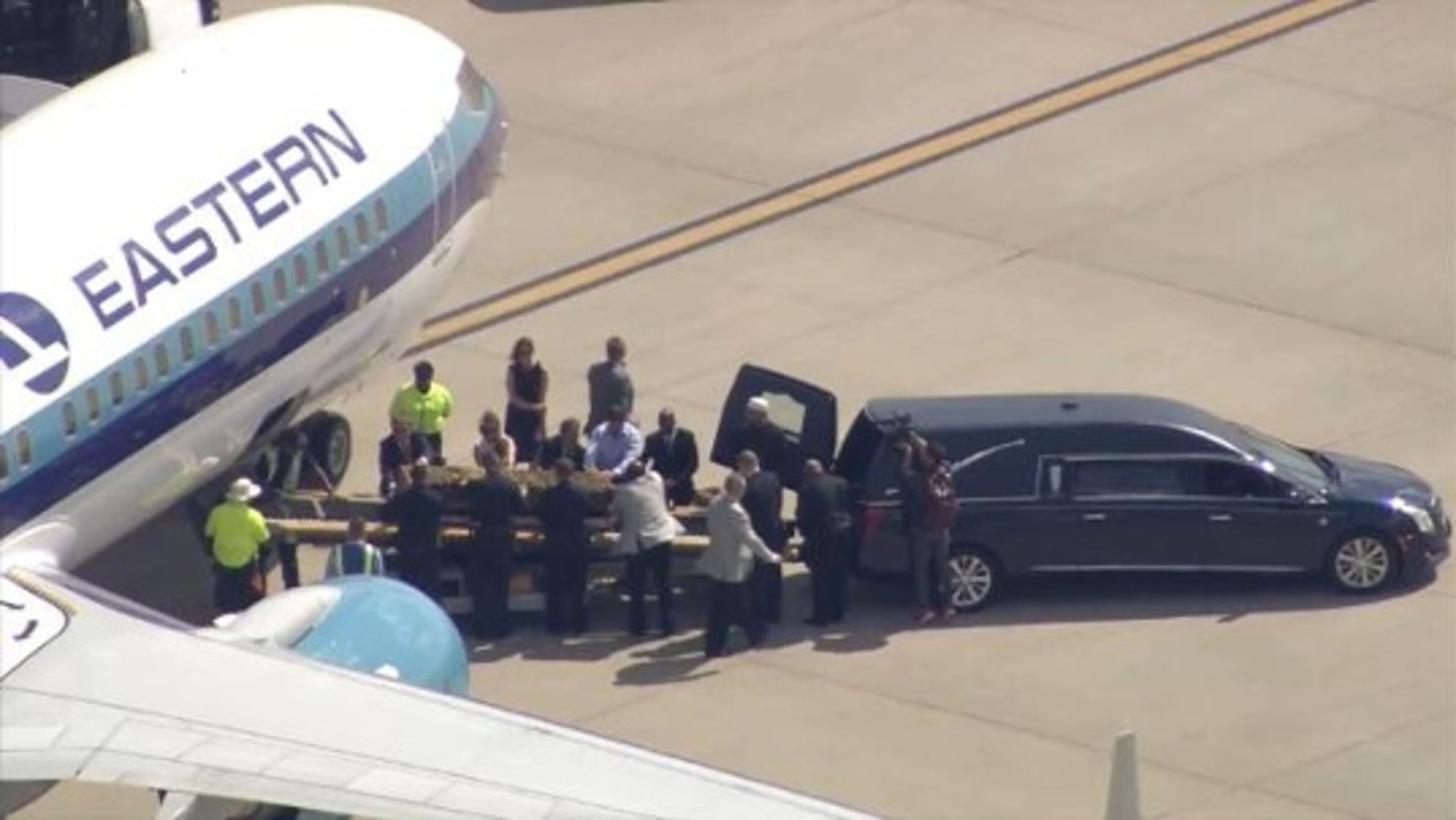 This image made from a video provided by WLKY-TV shows Muhammad Ali's casket being loaded into a hearse at Louisville International Airport, Sunday, June 5, 2016. Ali, the magnificent heavyweight champion whose fast fists and irrepressible personality transcended sports and captivated the world, died Friday at the age of 74. (WLKY-TV via AP)